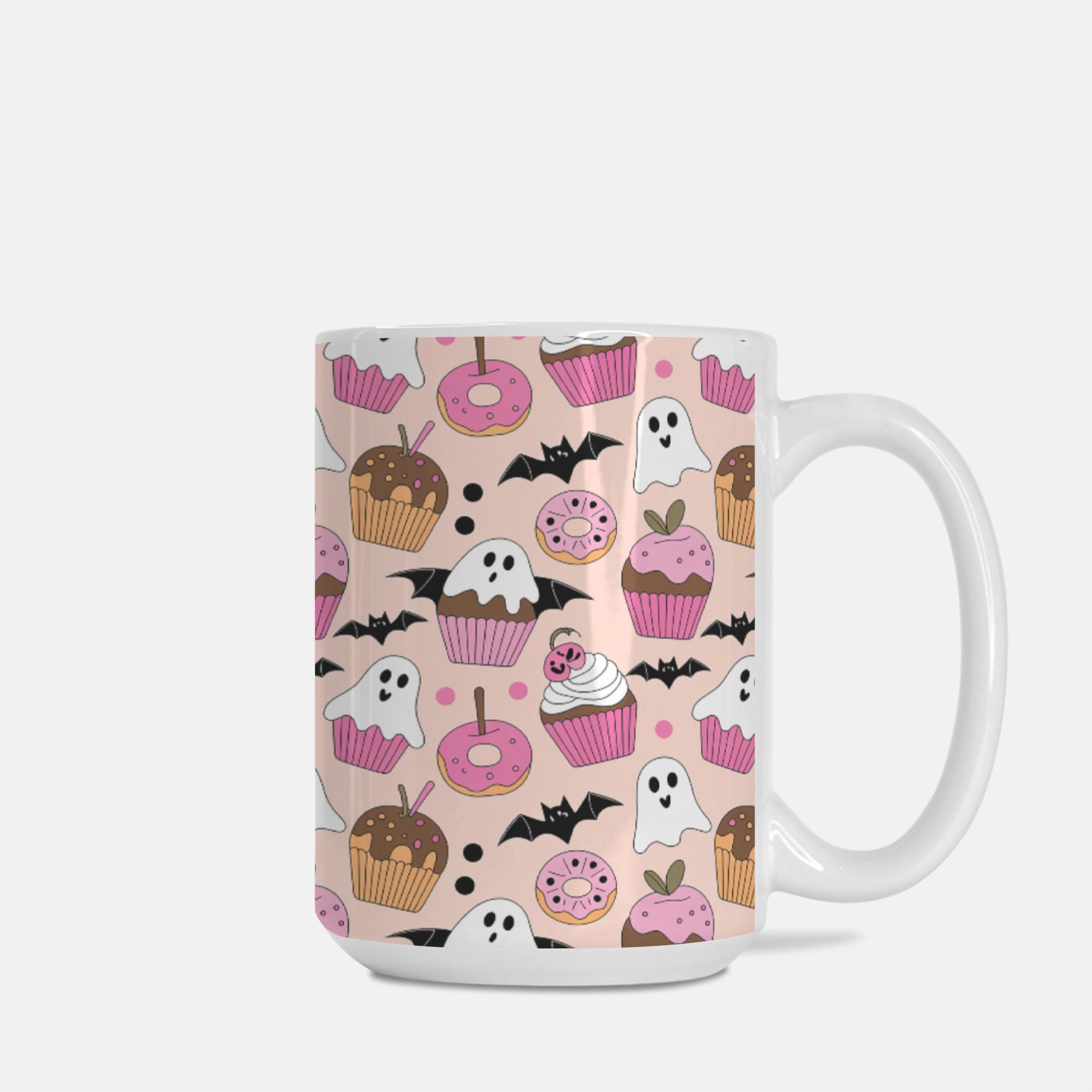 Mug with Halloween-themed pattern featuring ghosts, pumpkins, and donuts on a pink background.
