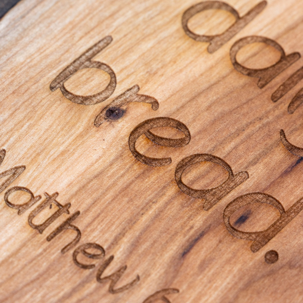 All boards are wood burn engraved. Close up of wood burned engraving.