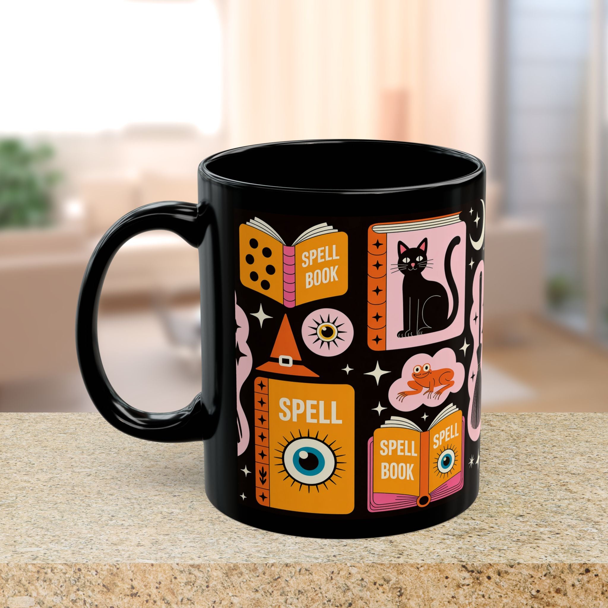 Black mug with colorful magic-themed designs on a blurred background