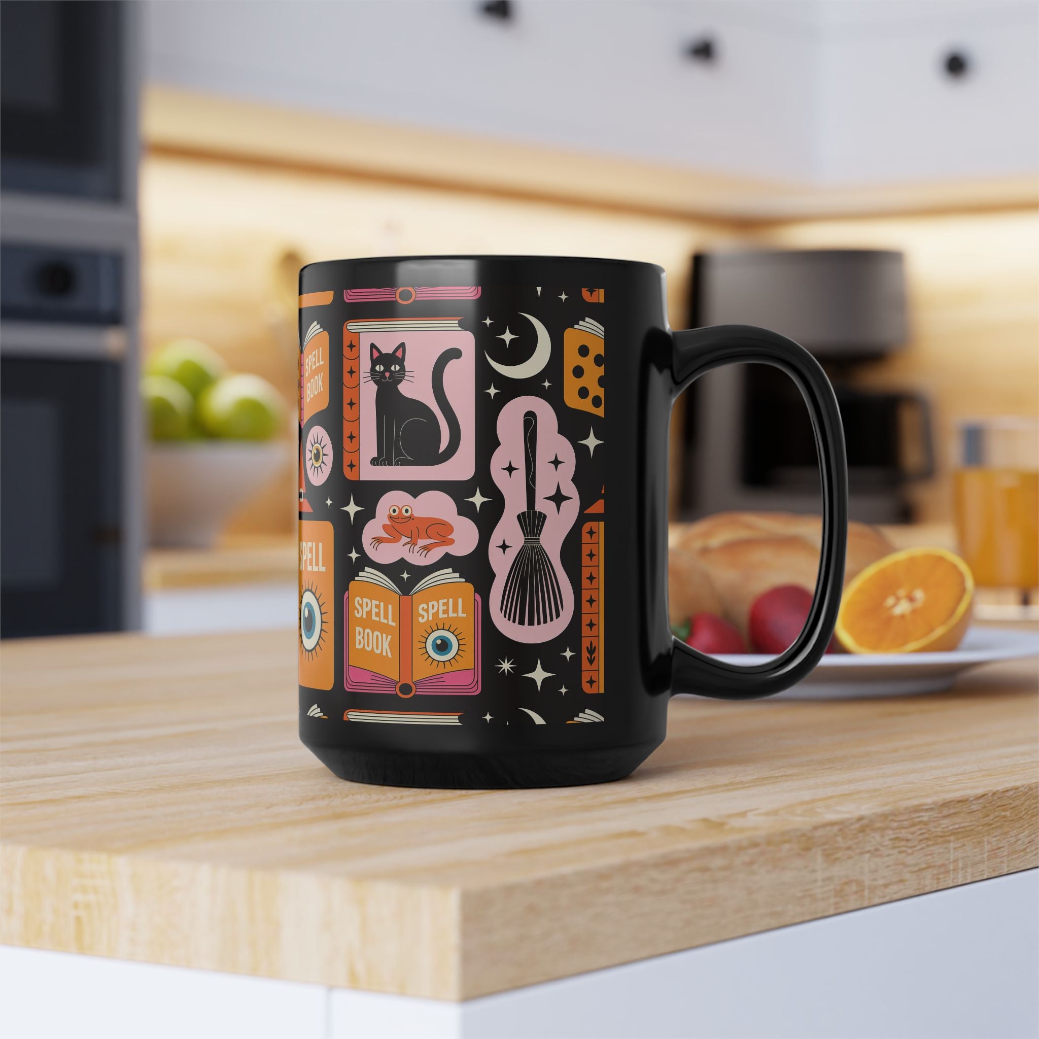 Black mug with colorful Black Cat Spells design on a kitchen counter
