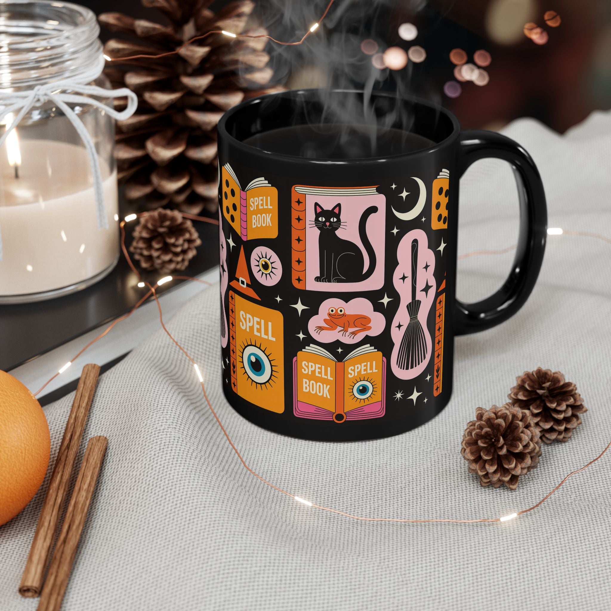 Black mug with Halloween-themed design on a table with decorative items