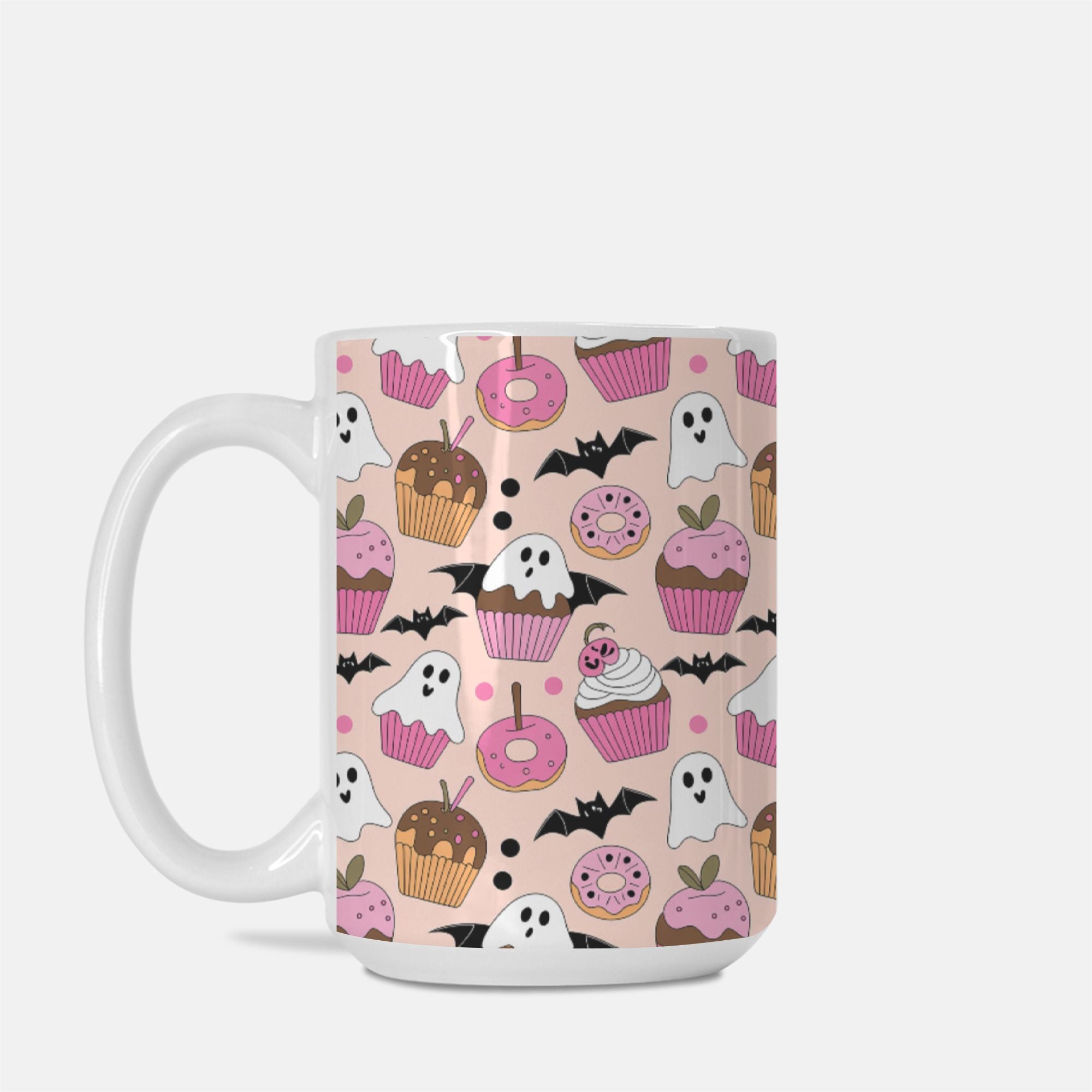 Mug with Halloween-themed design featuring ghosts, pumpkins, and donuts on a pink background.
