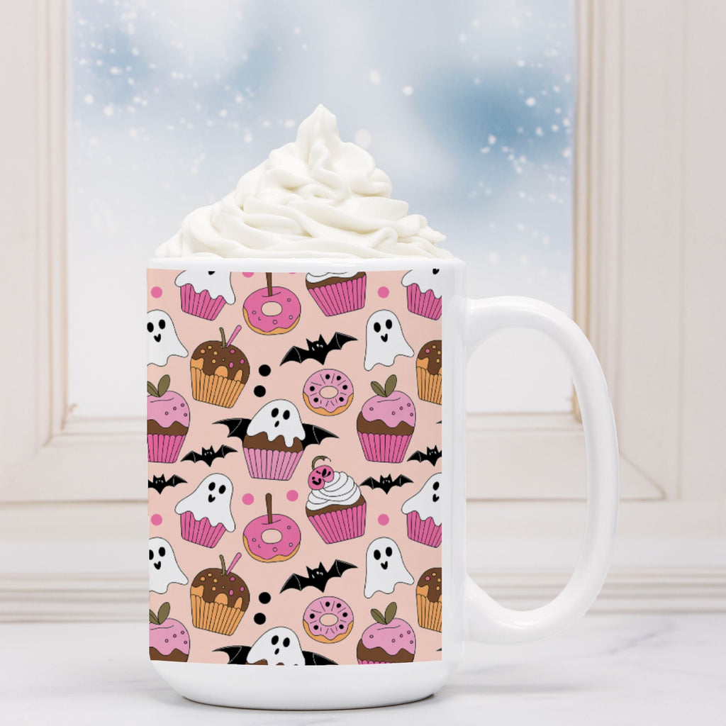 White mug with Halloween-themed cupcake and ghost pattern on a light background