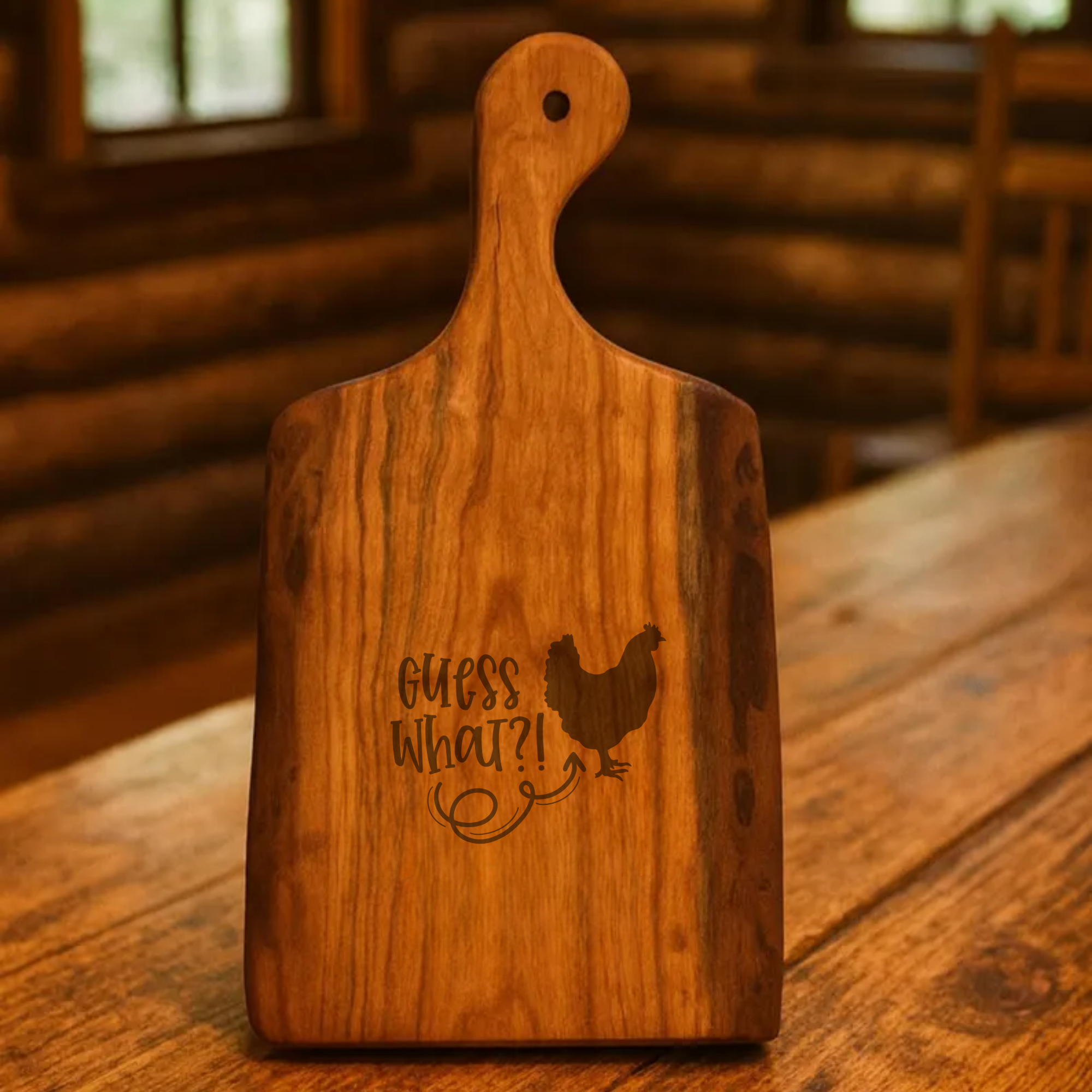 Wooden cutting board with engraved text and chicken illustration on a wooden surface.