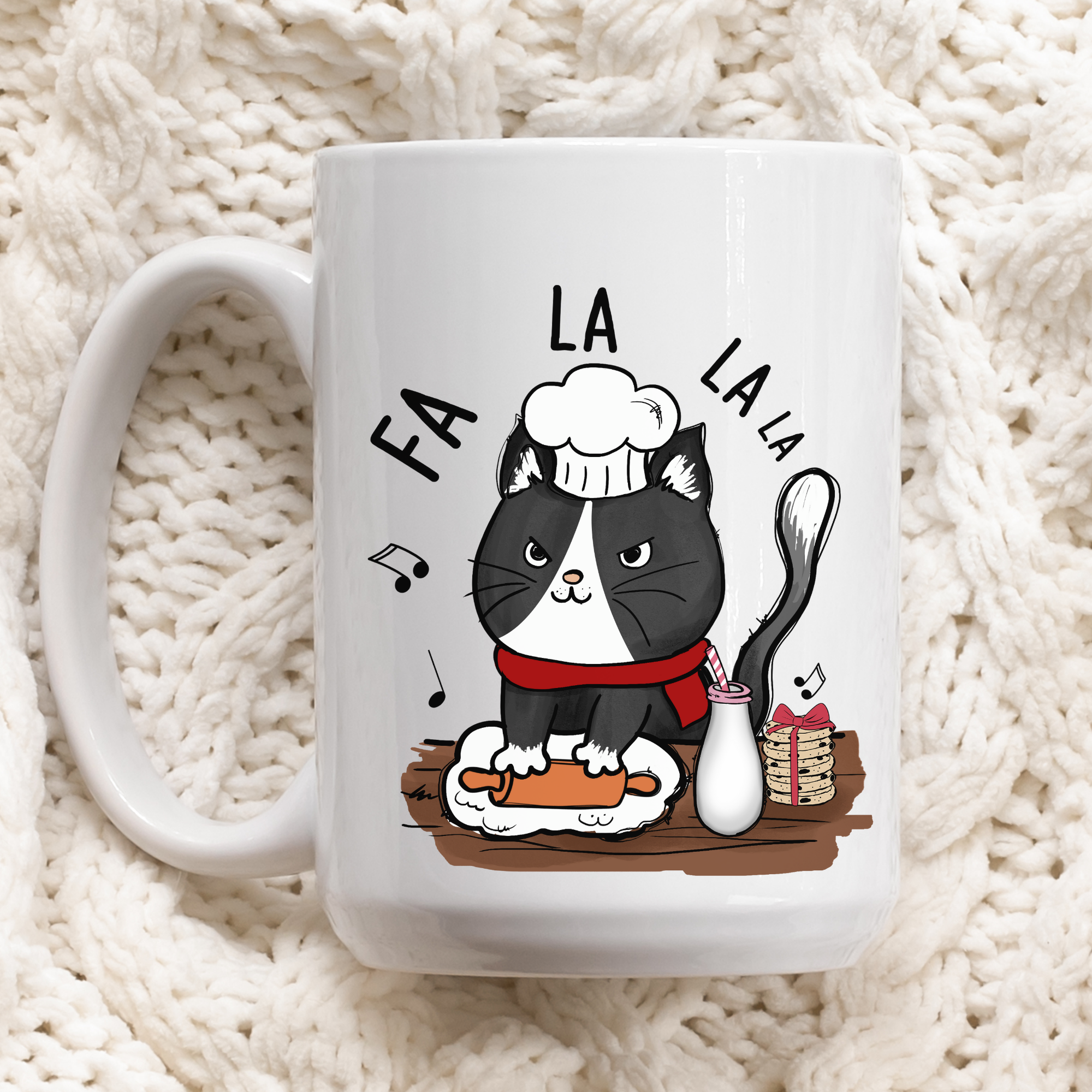 White mug with a cat illustration and 'Fa La La' text on a white textured background