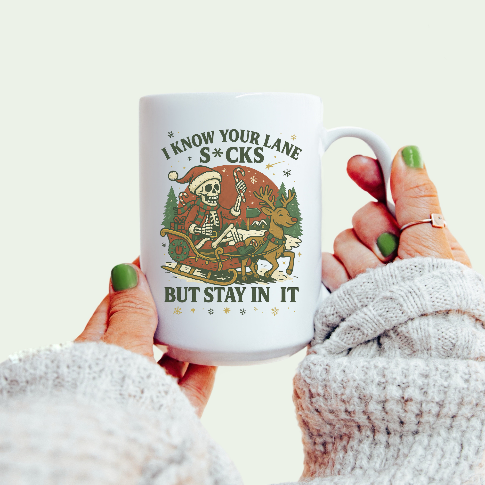 Person holding a mug with a graphic design and text on a light background