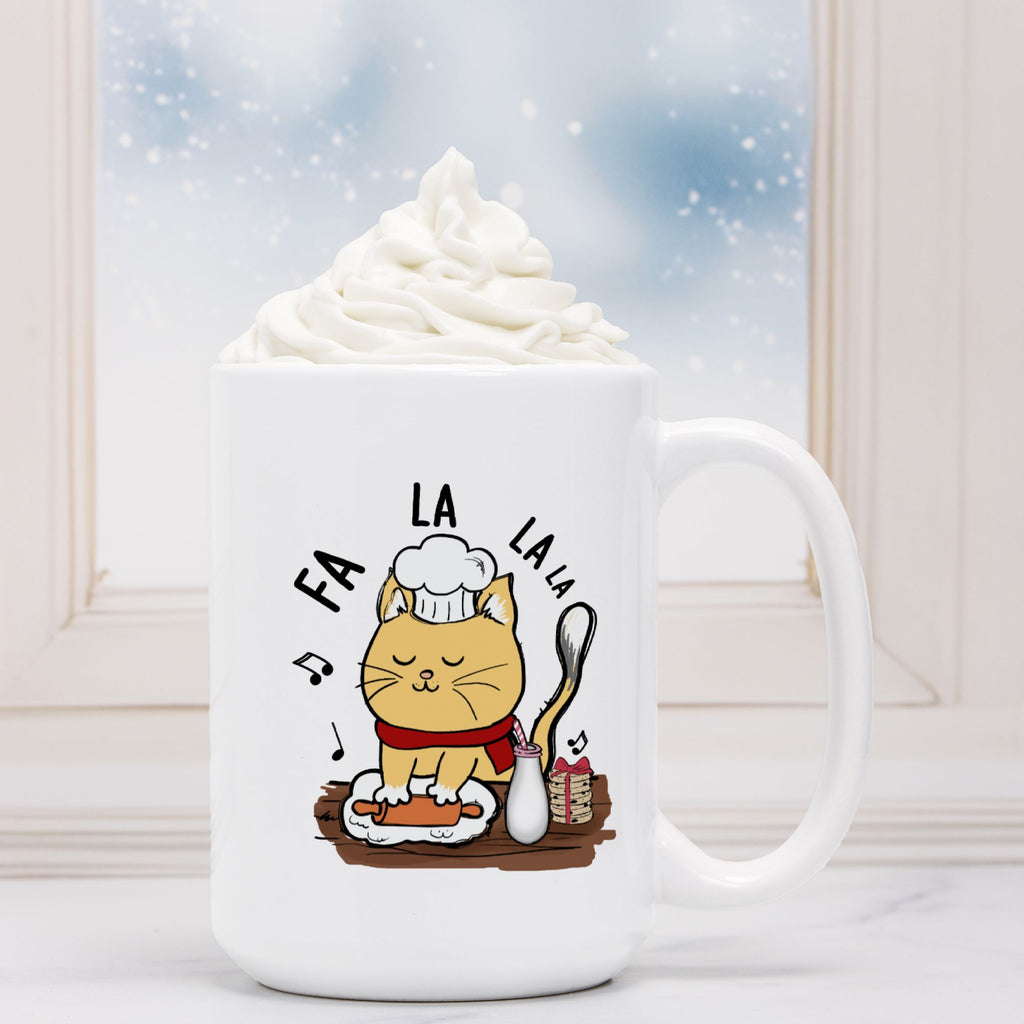 White mug with a cat illustration and 'FA LA LA LA' text, filled with hot chocolate.