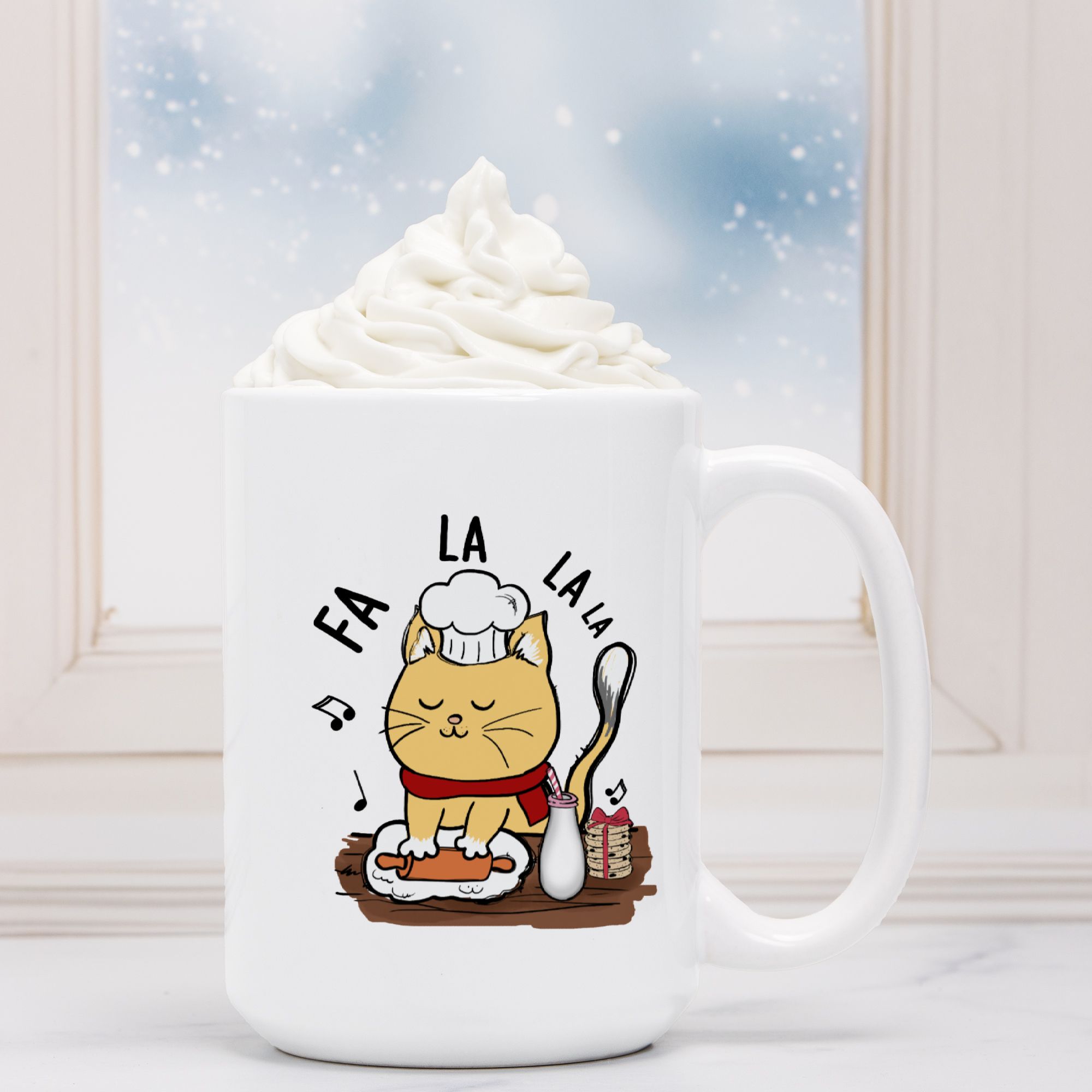 White mug with a cat illustration and 'FA LA LA LA' text, filled with hot chocolate.
