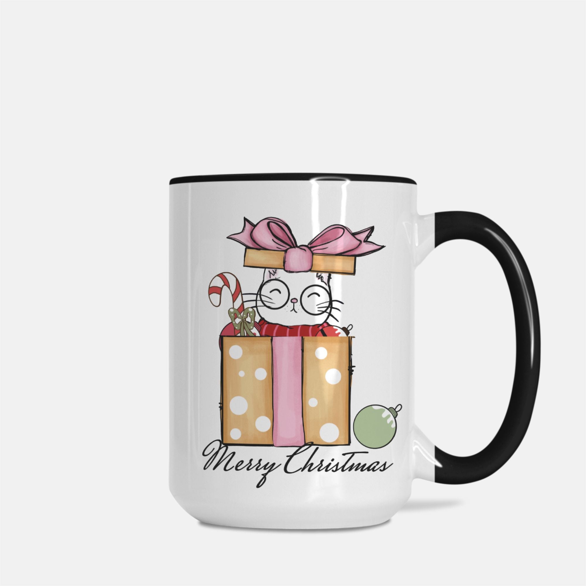 White mug with black handle featuring a Christmas-themed design of a cat with presents and 'Merry Christmas' text.
