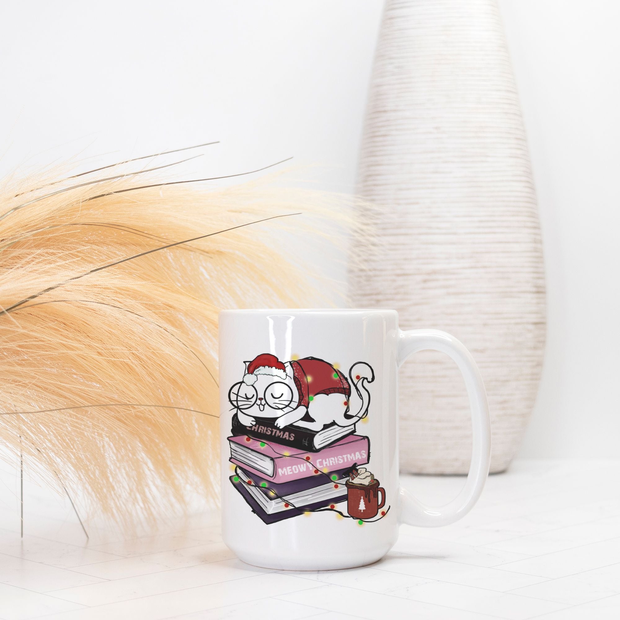 White mug with a Christmas-themed design featuring a cat and books on a white background.