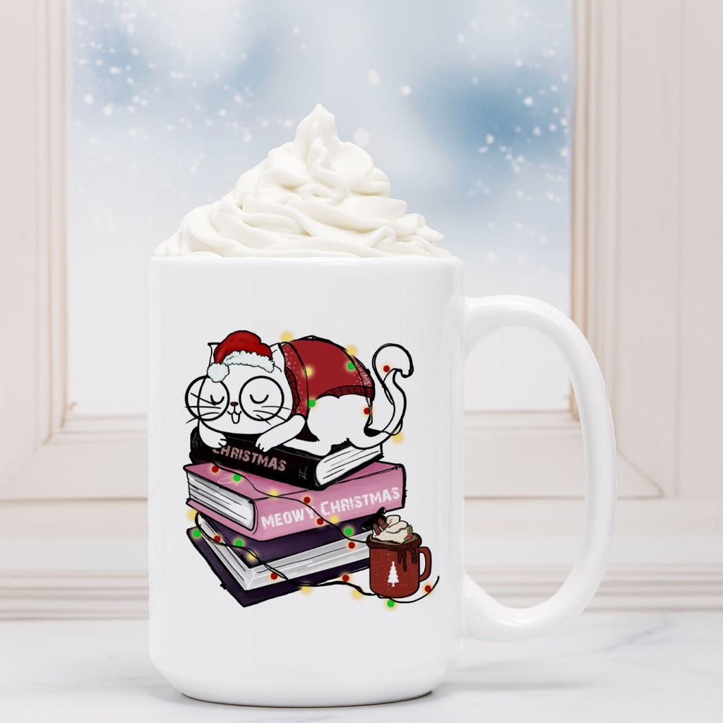 White mug with Christmas-themed design featuring a cat, books, and a hot cocoa cup, against a snowy window background.