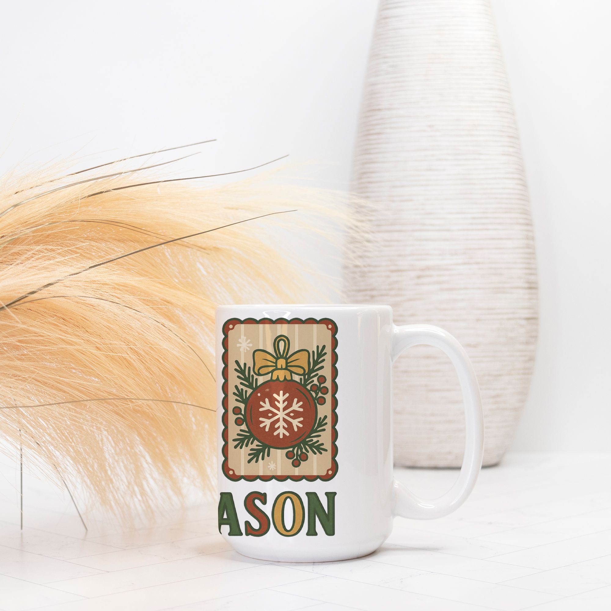 White mug with decorative design and 'Tis The Season' text on a light background