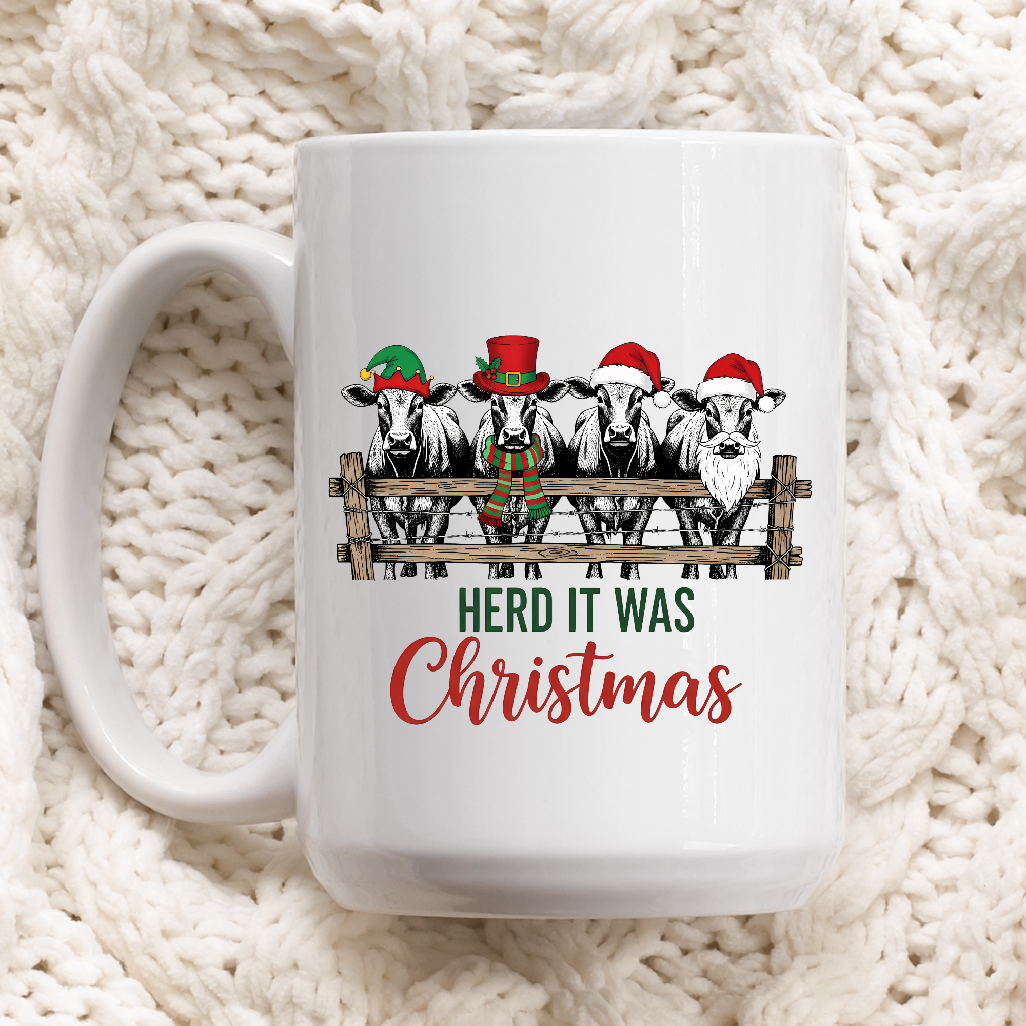 White mug with Christmas-themed design of cows wearing hats and the text 'Herd It Was Christmas' on a white textured background.