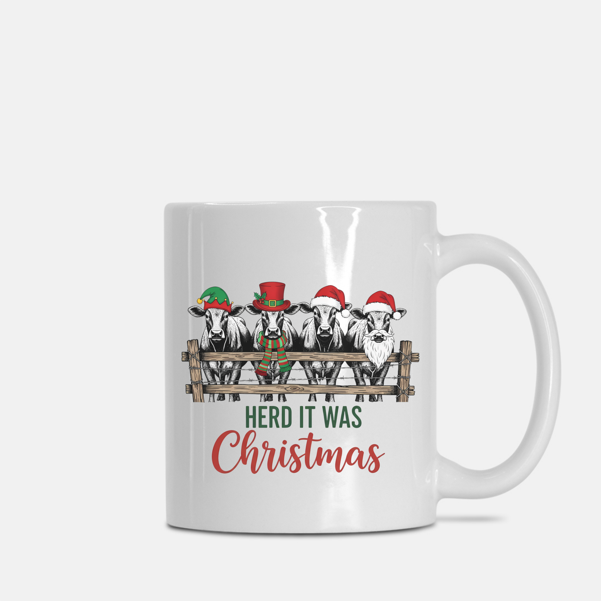White mug with Christmas-themed design of cows wearing Santa hats and text 'Herd it was Christmas' on a white background.
