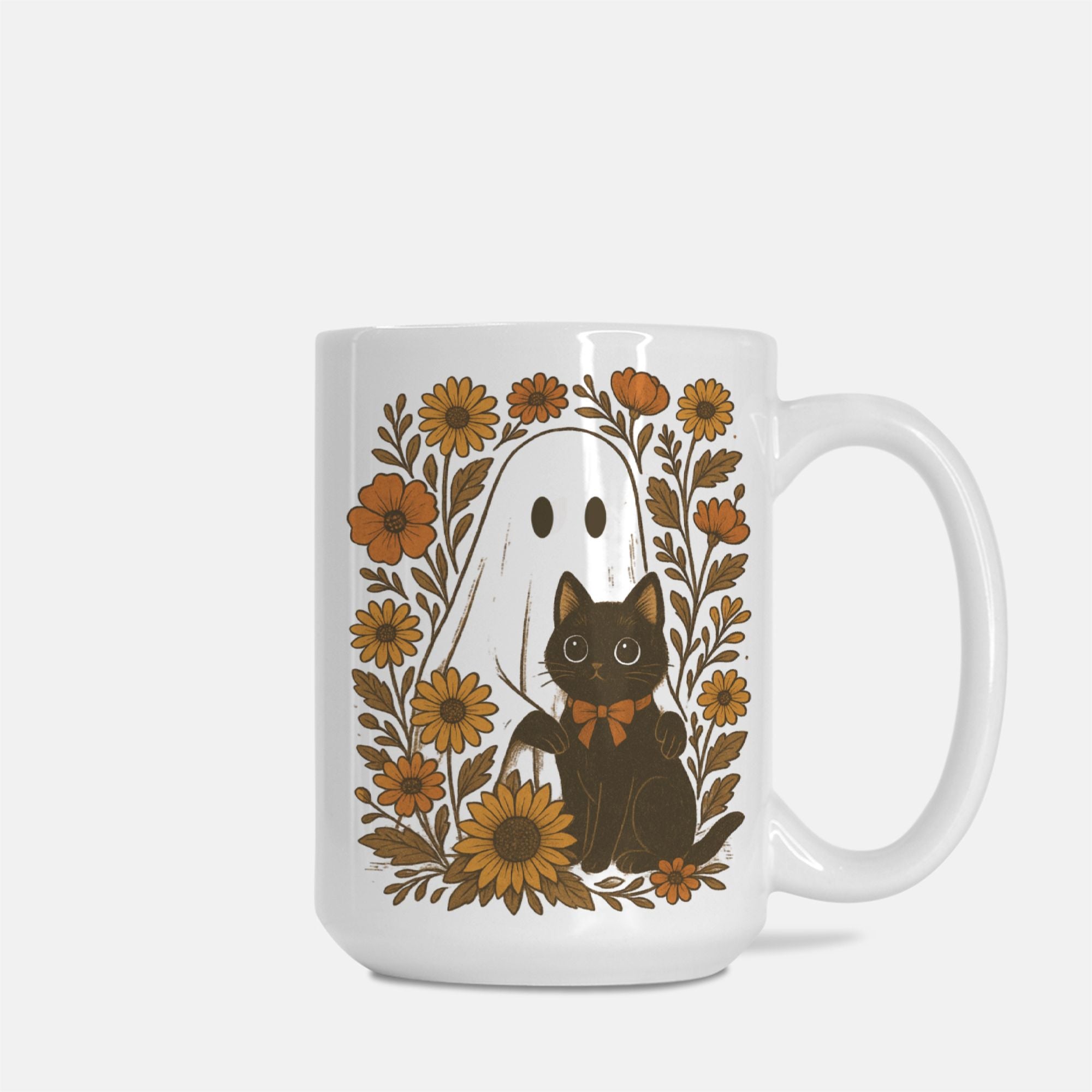 White mug with a design of a black cat, ghost, and flowers on a white background