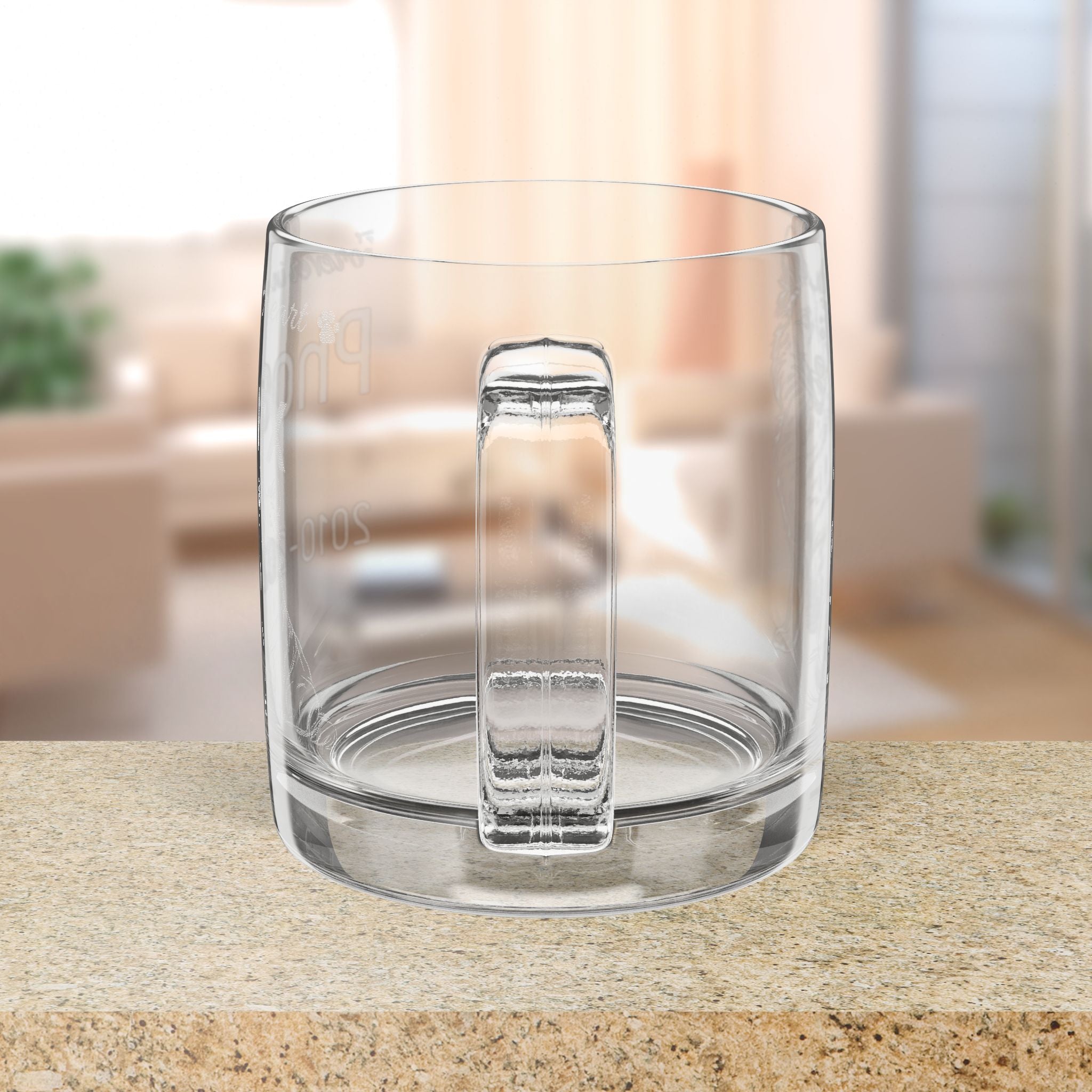 Clear glass mug on a countertop with a blurred indoor background