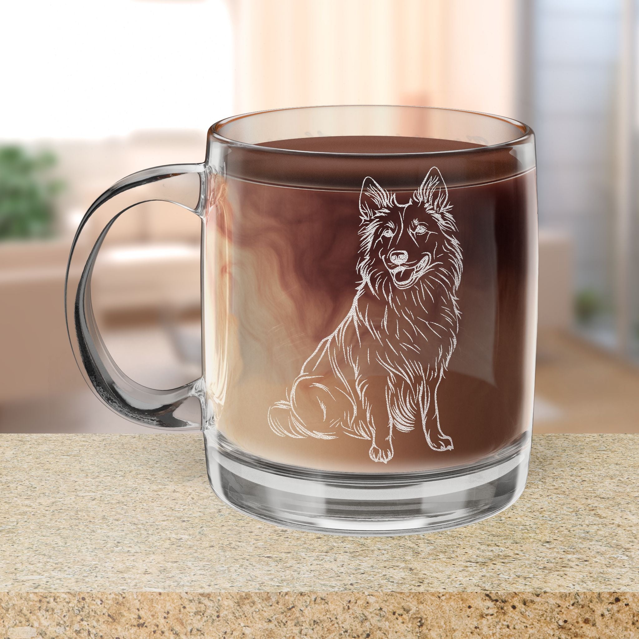 Clear glass mug with an engraved Belgian Shepherd dog illustration filled with hot chocolate on a wooden surface.