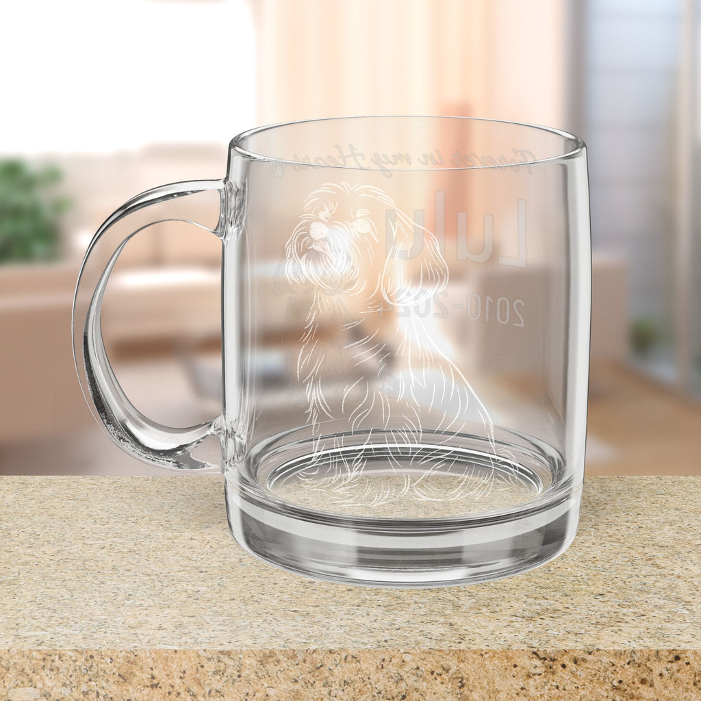 Clear glass mug with engraved Bichon Frise design on a wooden surface