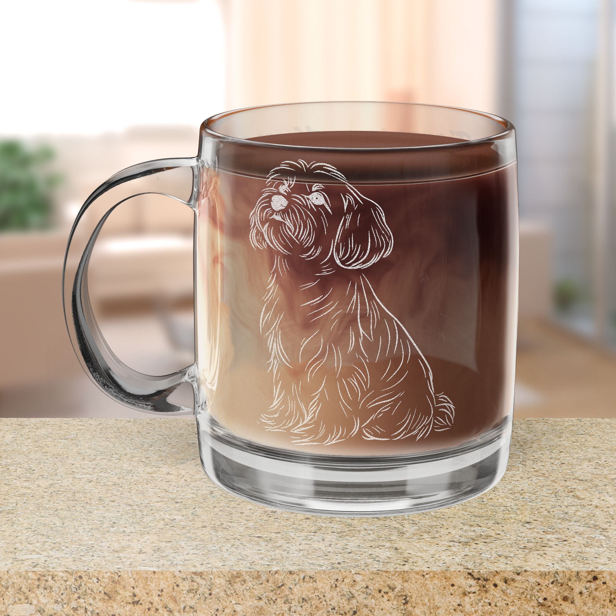 Clear glass mug with a dog illustration filled with hot chocolate on a wooden surface.