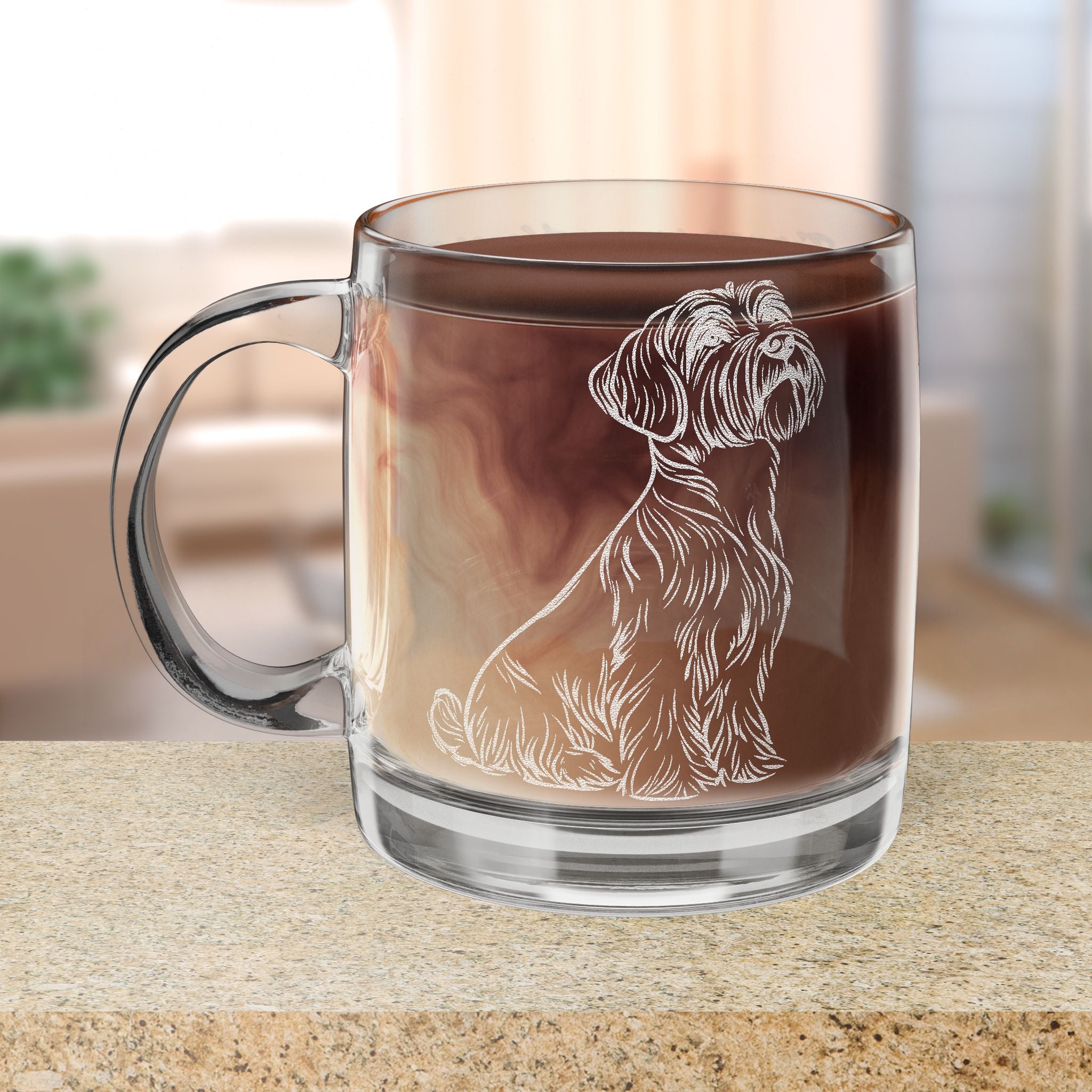 Clear glass mug with a Black Russian Terrier dog engraving filled with hot chocolate on a wooden surface.