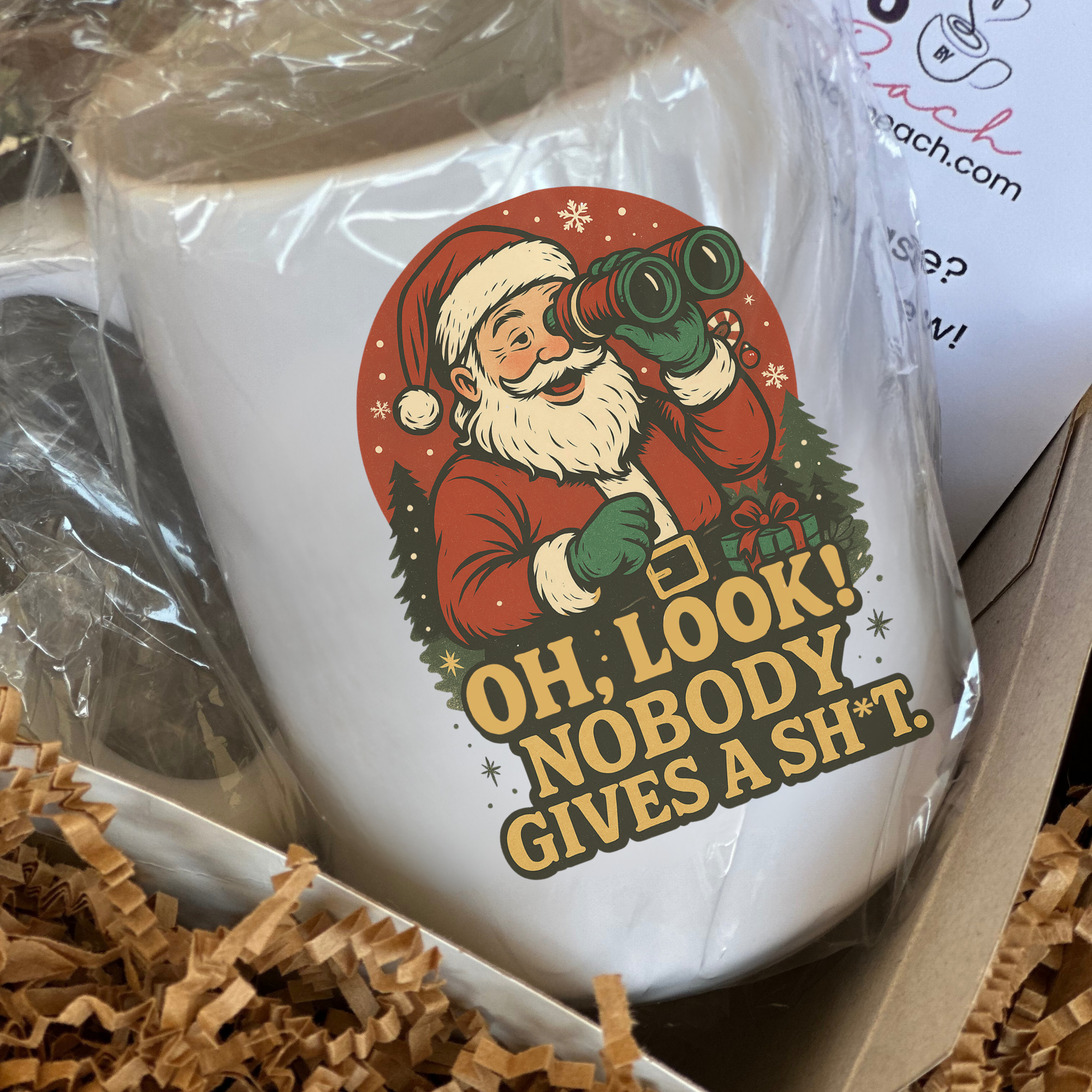 White mug with Santa Claus graphic and text in a box