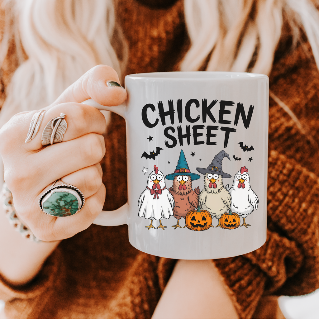 Person holding a mug with Halloween-themed design featuring chickens in costumes and the text 'Chicken Sheet'.