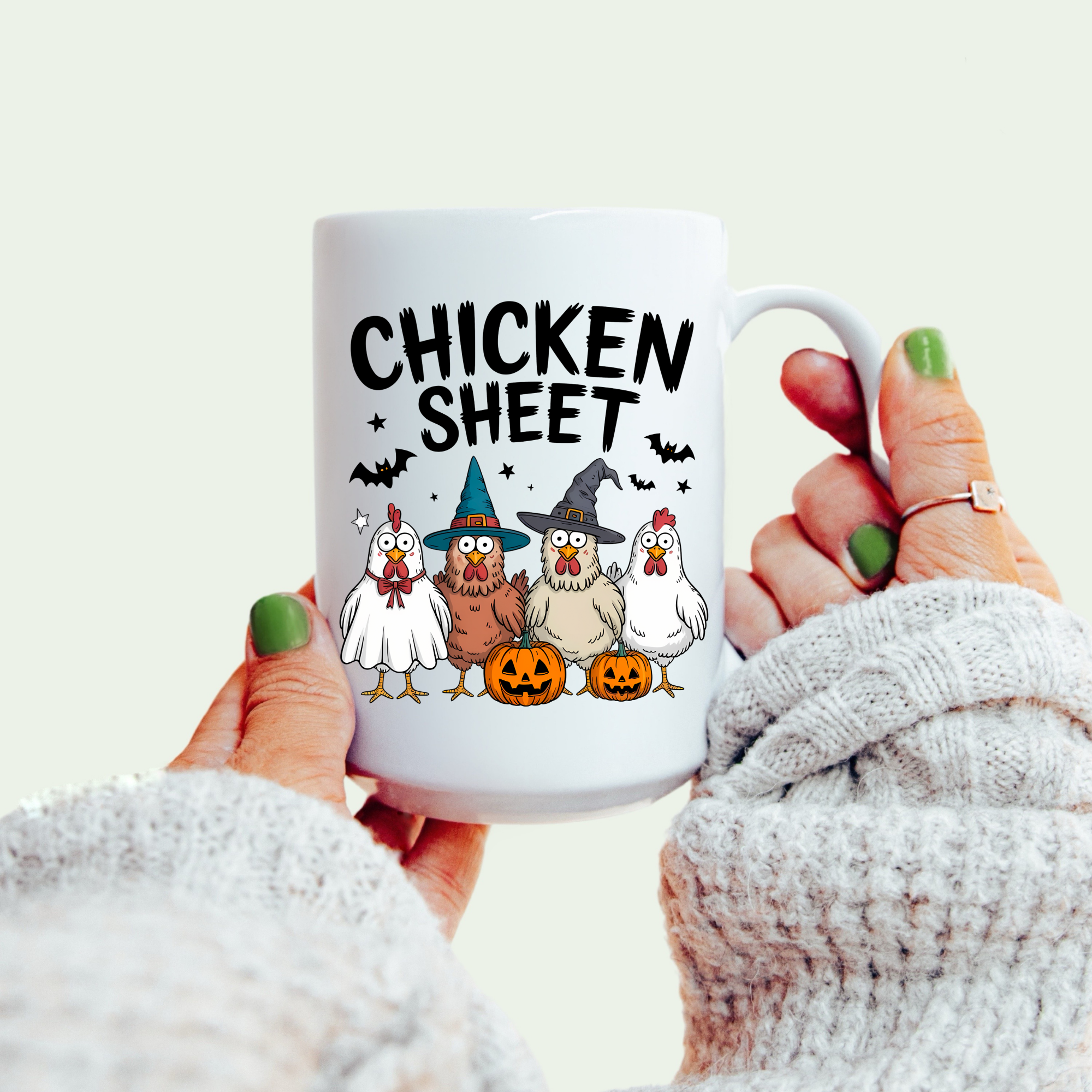 Mug with 'Chicken Sheet' text and cartoon chickens in costumes held by a person.
