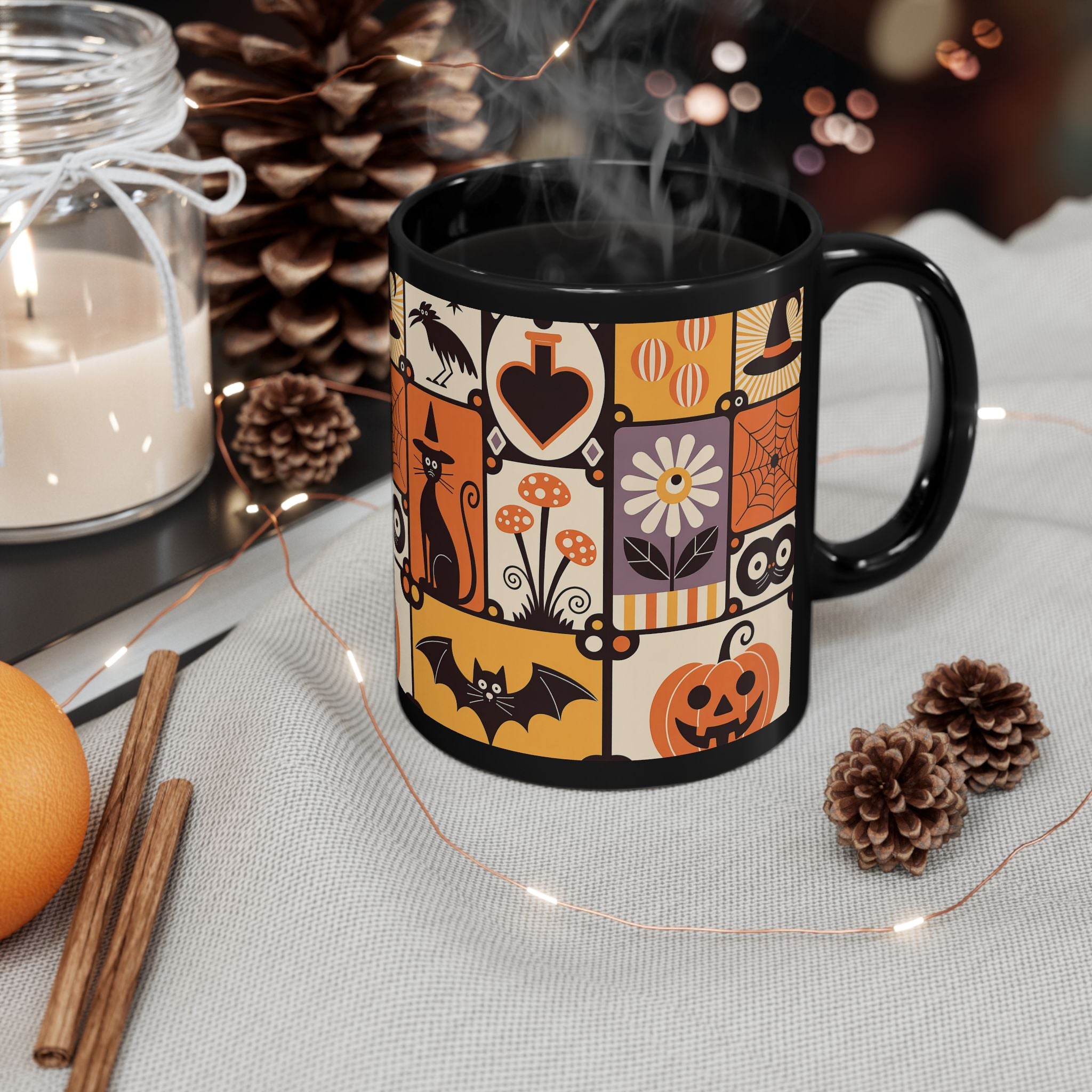 Black mug with Halloween-themed design on a table with decorative items