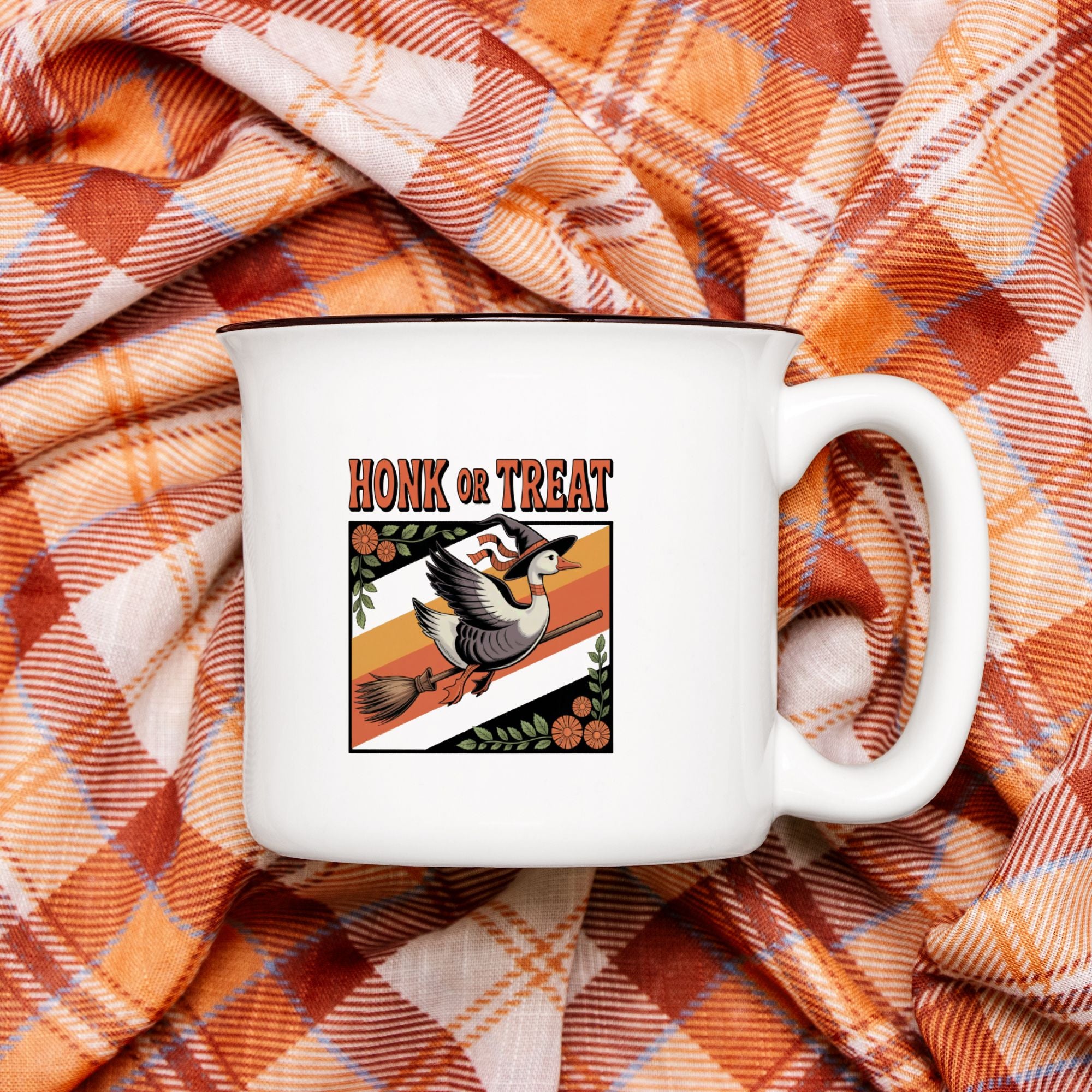 White mug with 'Honk or Treat' design on plaid fabric