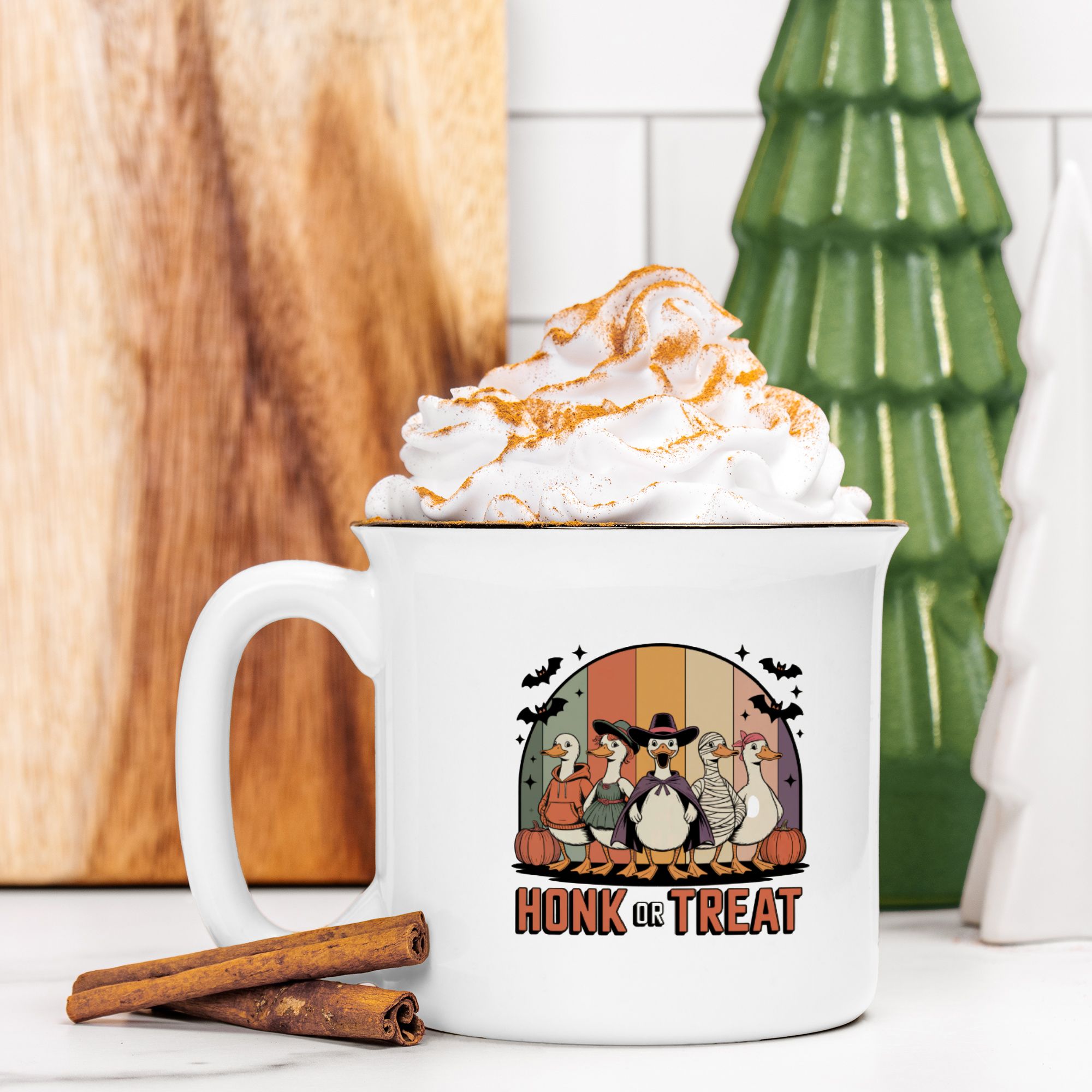 White mug with a Halloween goose design and 'Honk or Treat' text, filled with hot chocolate and whipped cream.