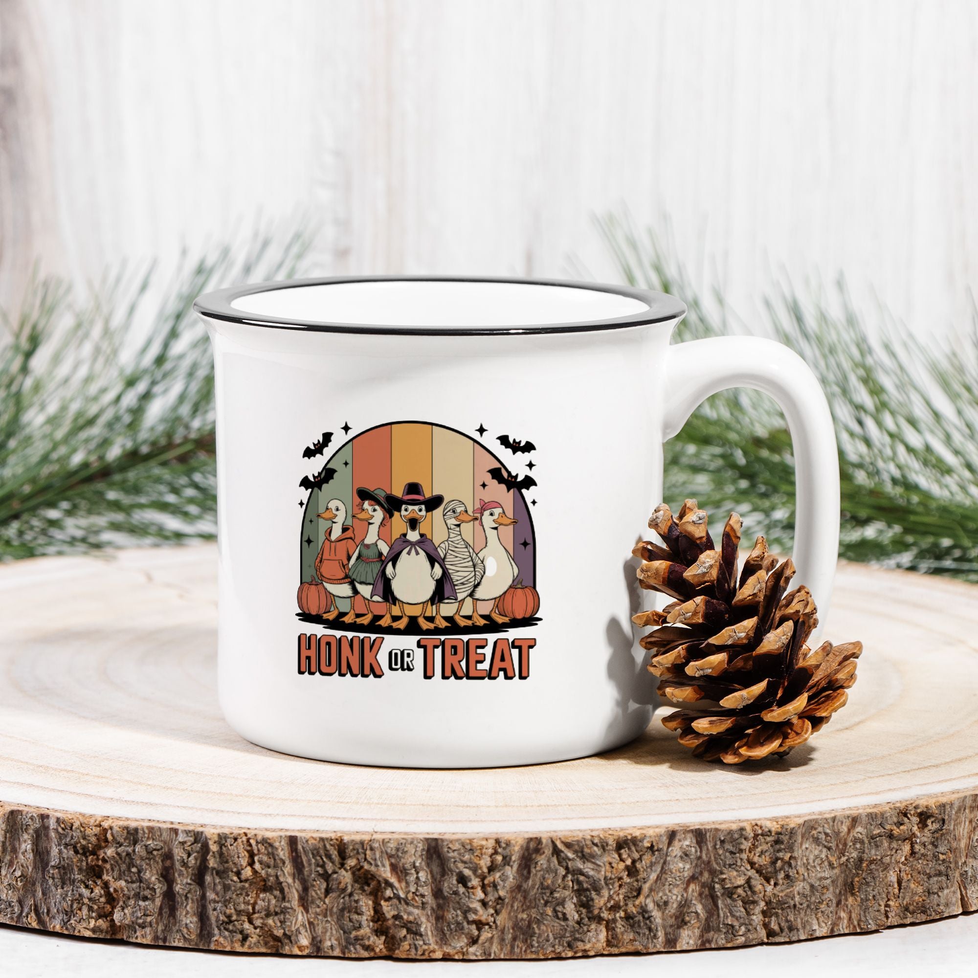 White mug with Halloween-themed design featuring cartoon character geese, surrounded by pine branches.