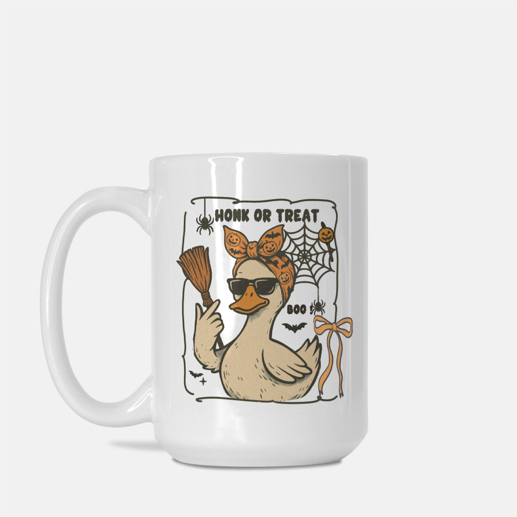 White mug with a Halloween-themed design featuring a duck, broom, and spider web on a white background.