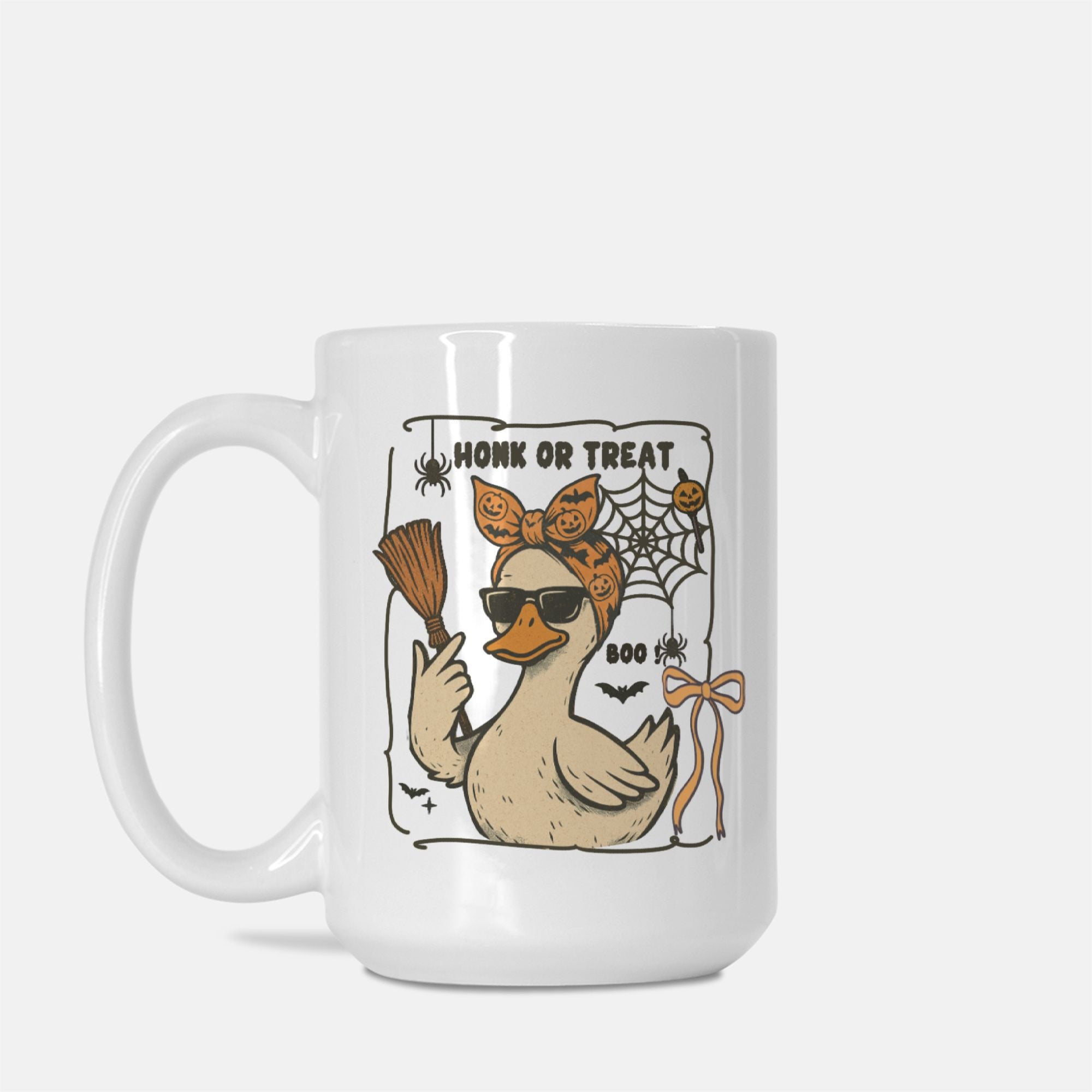 White mug with a Halloween-themed design featuring a duck, broom, and spider web on a white background.