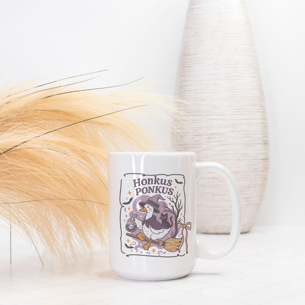 White mug with 'Honkus Ponkus' design featuring a penguin and broomstick on a white background.