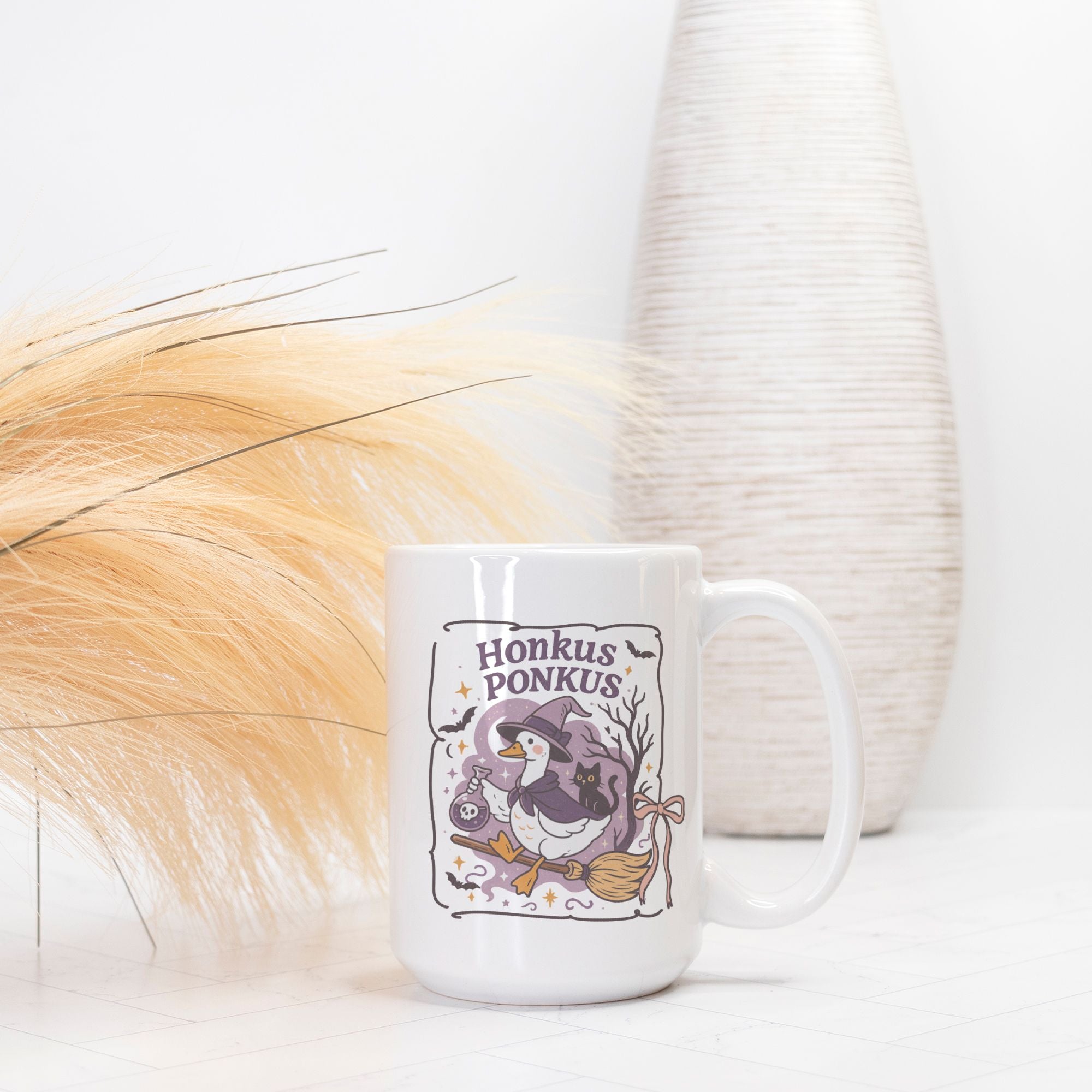 White mug with 'Honkus Ponkus' design featuring a penguin and broomstick on a white background.