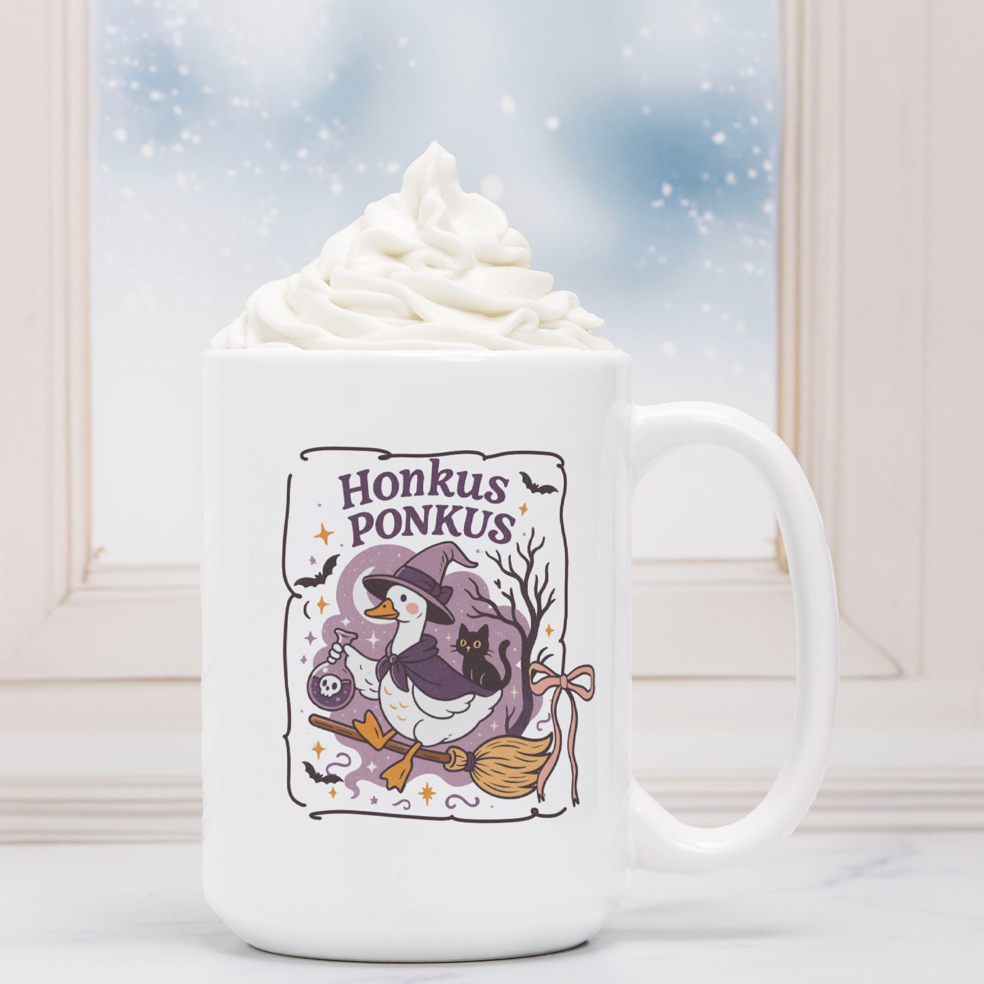 White mug with a cartoon penguin in a witch hat and cape, surrounded by Halloween-themed elements, with whipped cream on top.