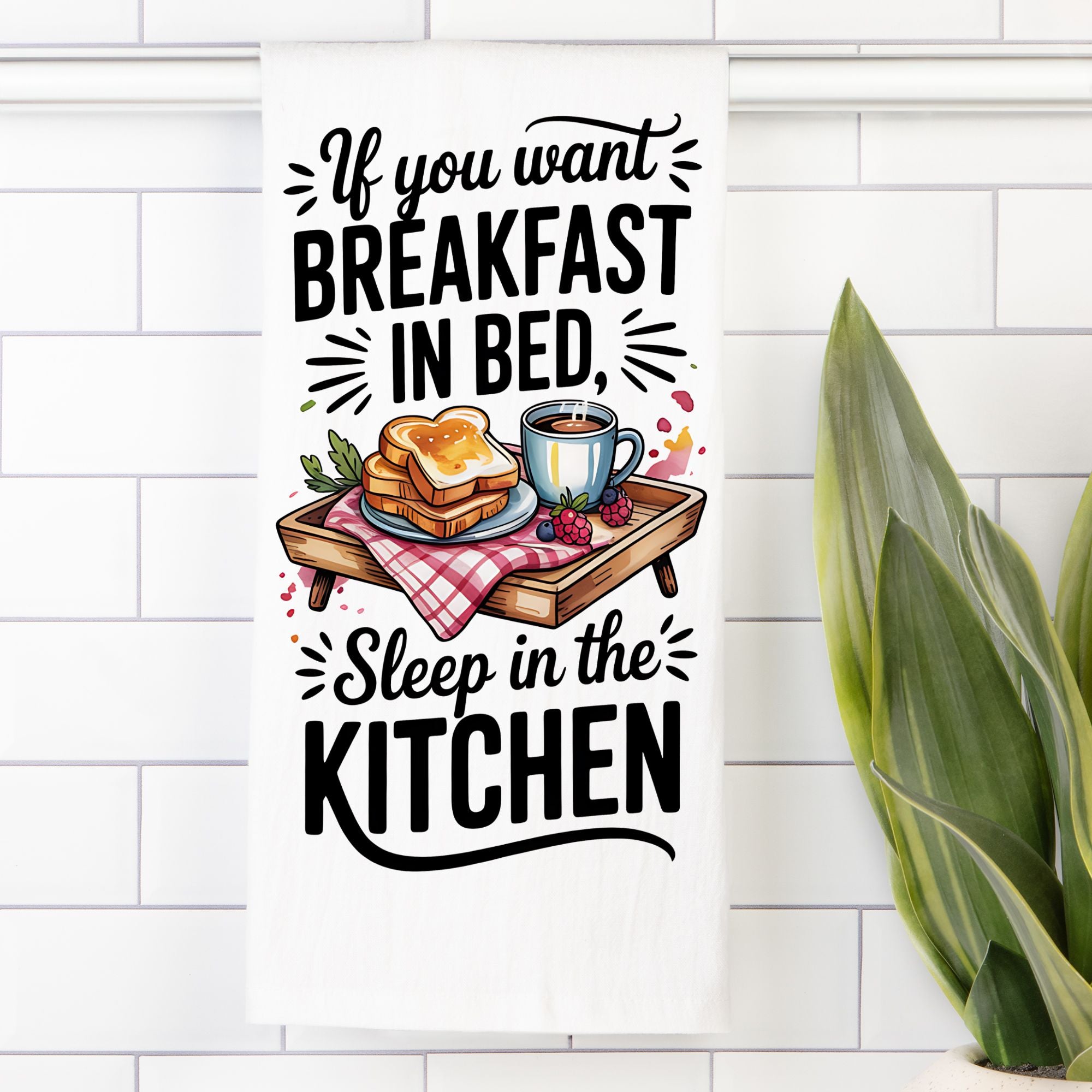 Funny Towel (flour sack) with breakfast illustration and text on a white tiled wall.
