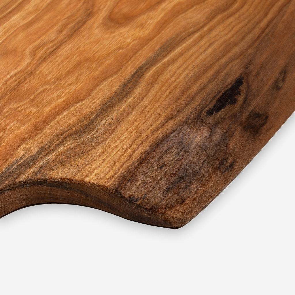Close-up of a wooden cutting board with a white background