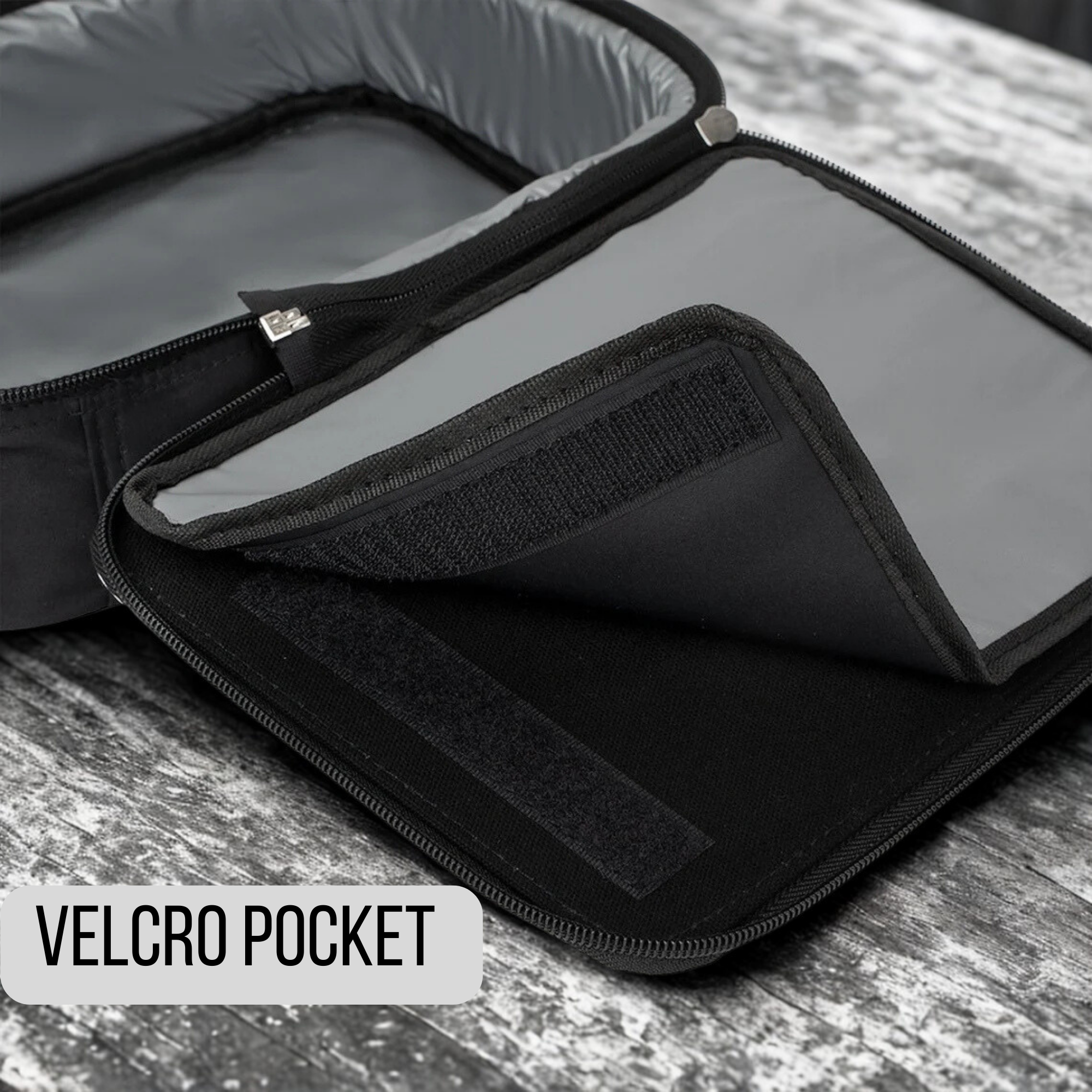 Black velcro pocket on a gray surface with 'VELCRO POCKET' text label.