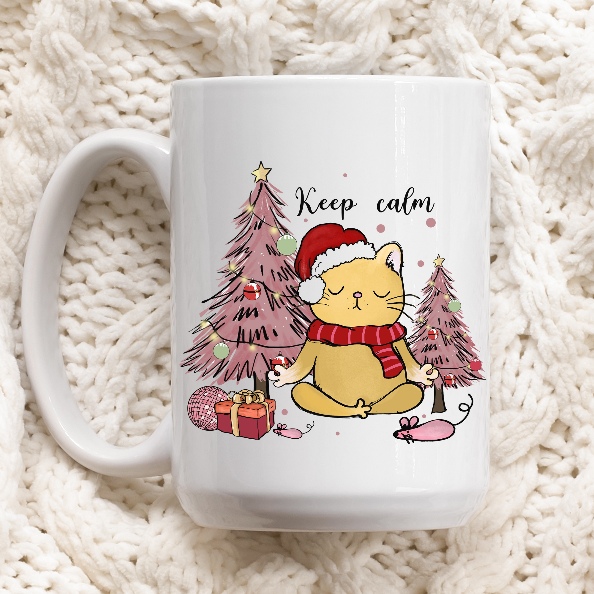 White mug with a cartoon cat in a Santa hat and Christmas tree design on a textured white background