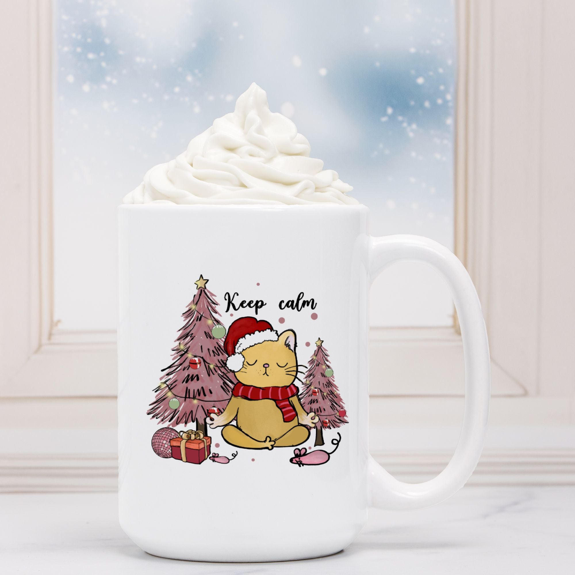 White mug with a cat wearing a Santa hat and Christmas trees design, filled with hot chocolate.