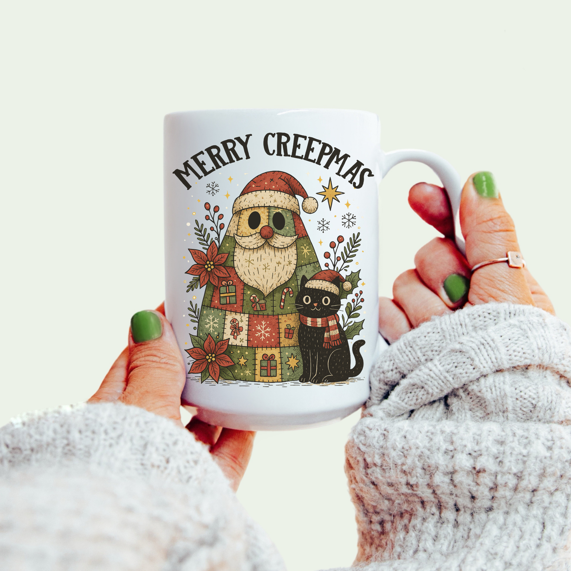 Mug with 'Merry Creepmas' design featuring a Santa Claus and black cat, held by a person wearing a white sweater.