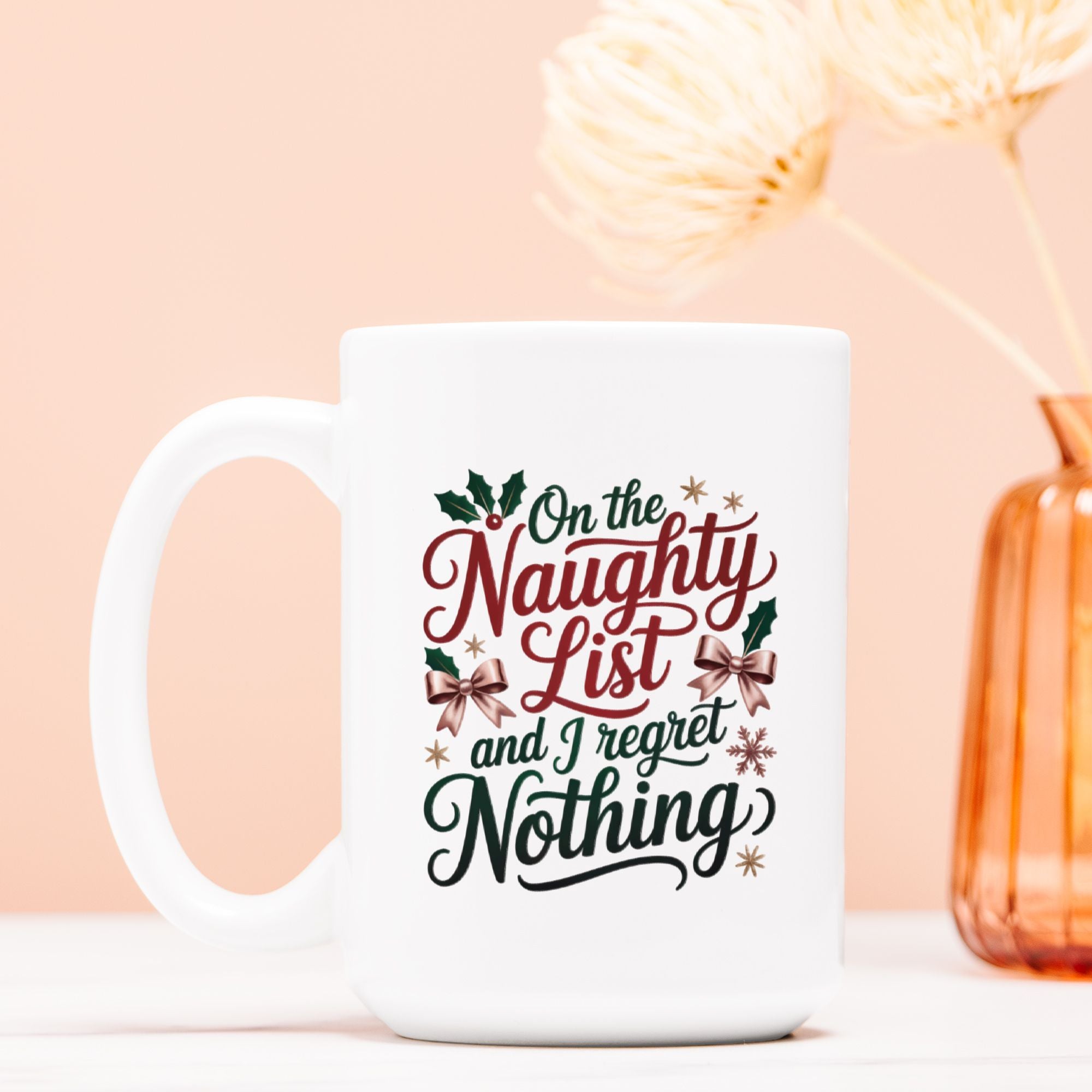 White mug with Christmas-themed text on a light pink background