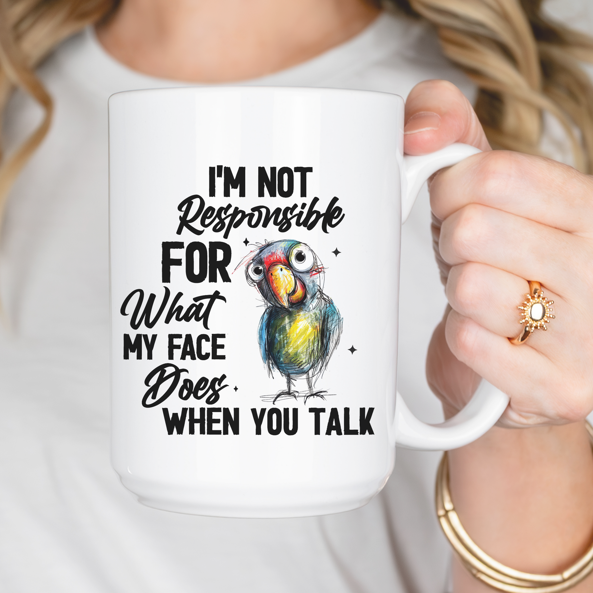 Hand drawn parrot with text ' I'm not responsible for what my face does when you talk' on white mug held by a person.