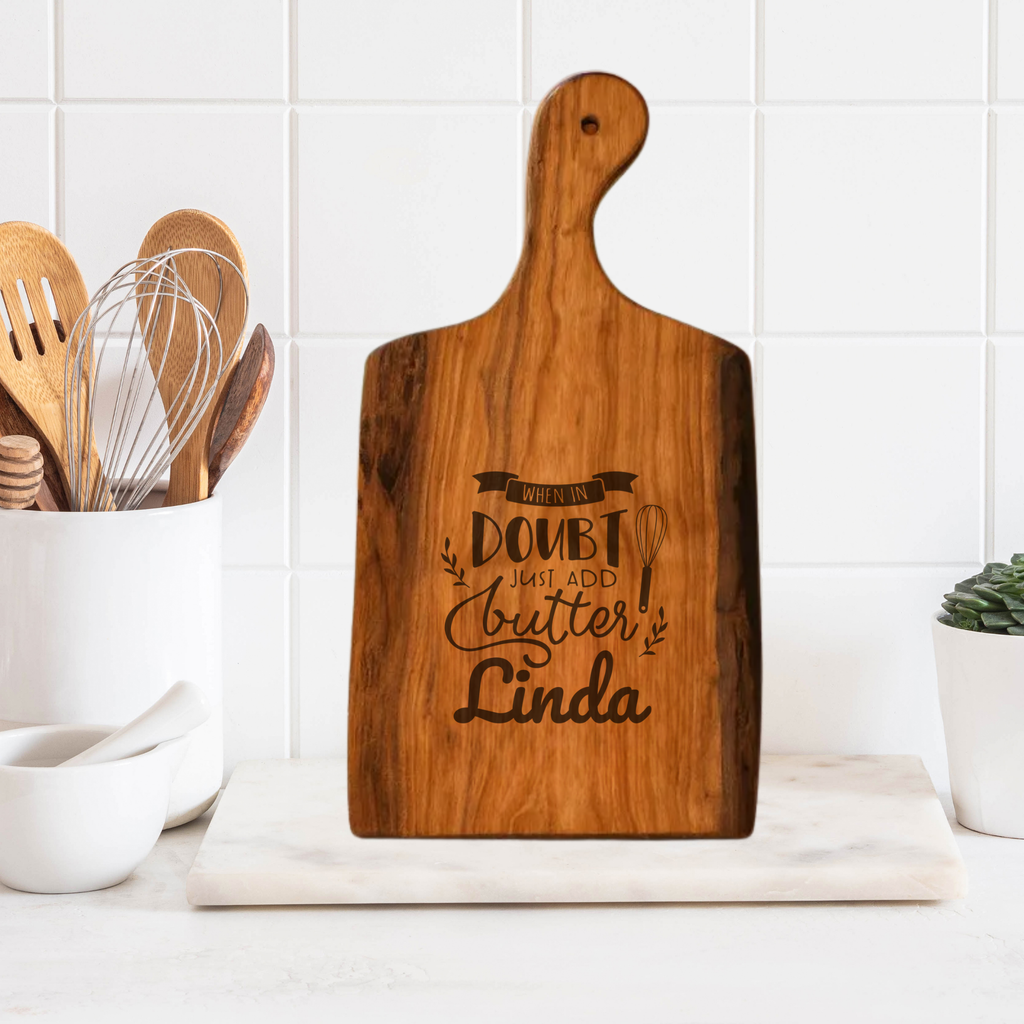 Wooden cutting board with engraved text in a kitchen setting