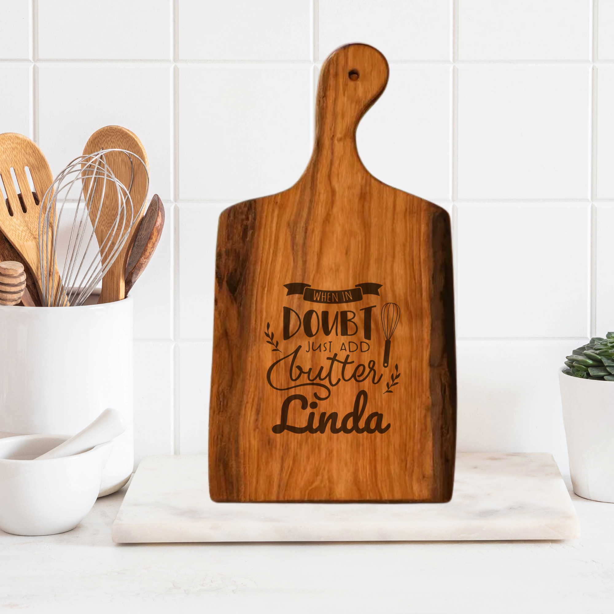 Wooden cutting board with engraved text in a kitchen setting