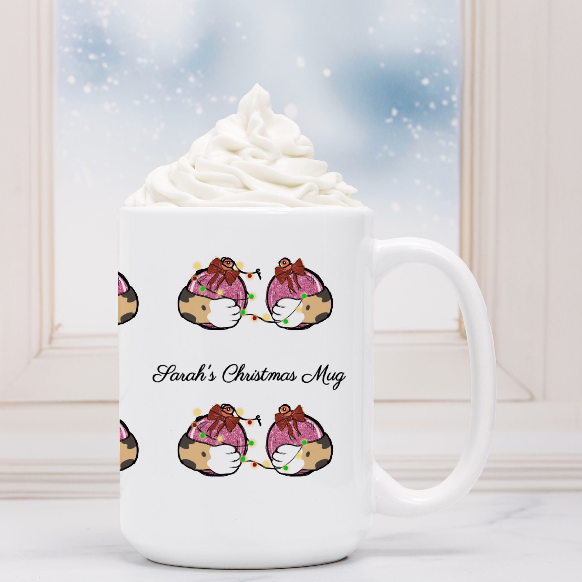 White mug with cartoon designs and 'Sarah's Christmas Mug' text, filled with hot chocolate and whipped cream.