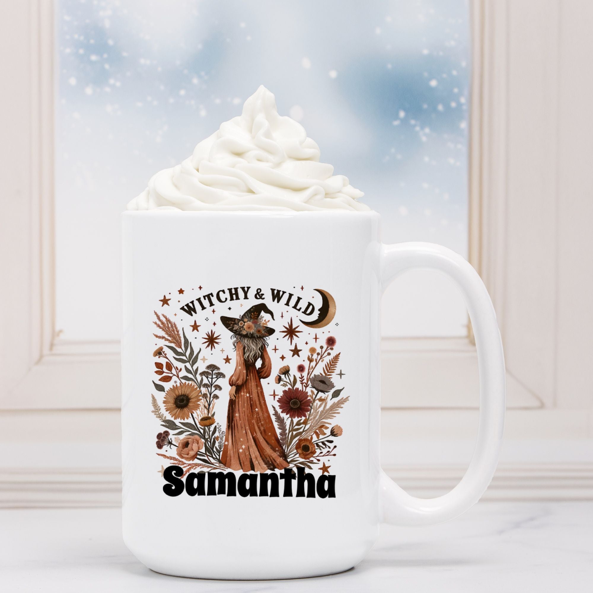 White mug with a fox and floral design, text 'Witchy & Wild Samantha', and whipped cream on a white surface.