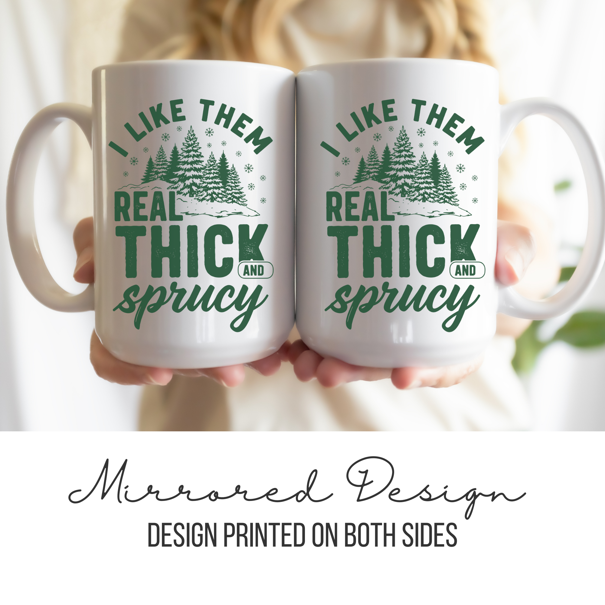 Two white mugs with mirrored green and white design held by a person.
