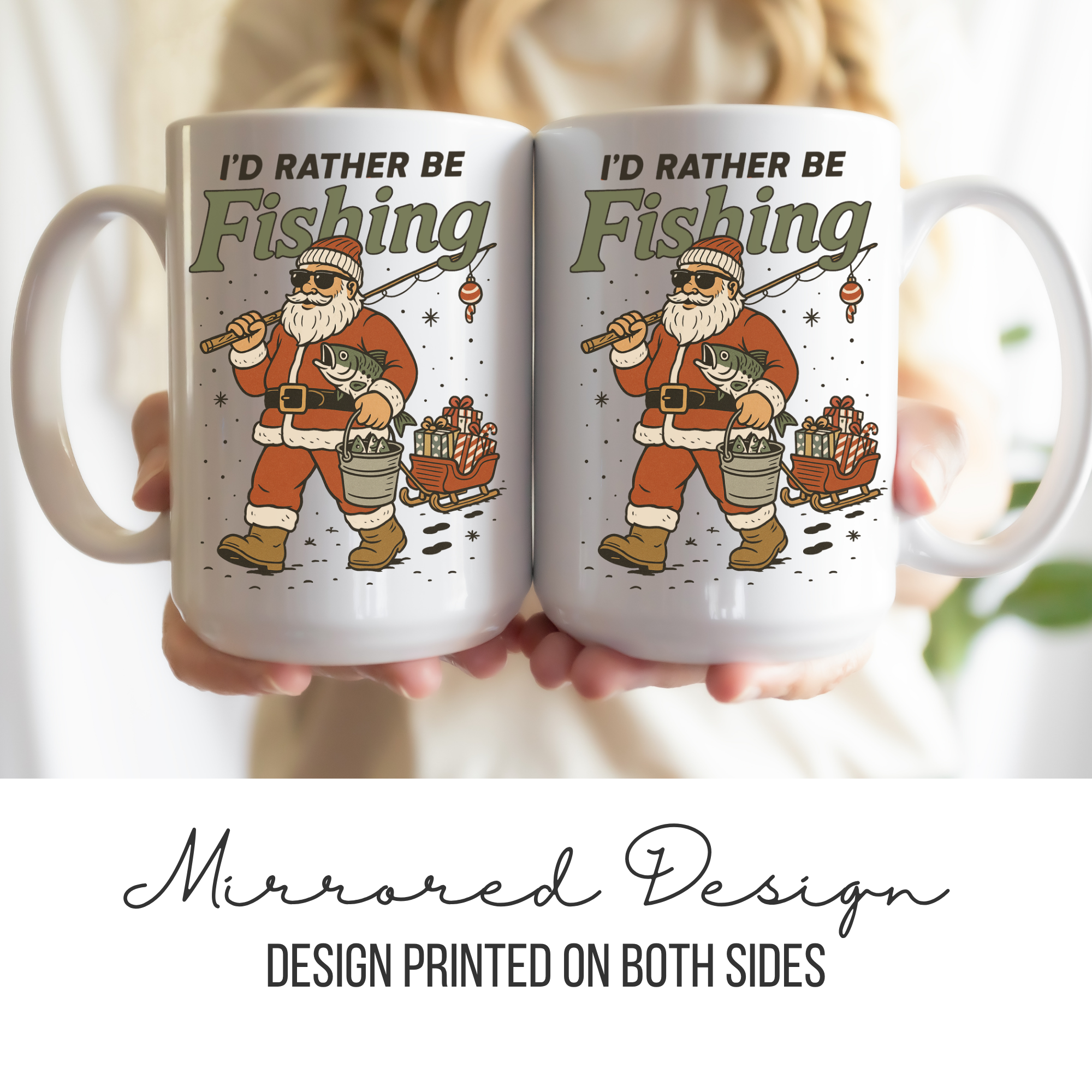 Two mugs with a mirrored design of Santa Claus fishing, held together.